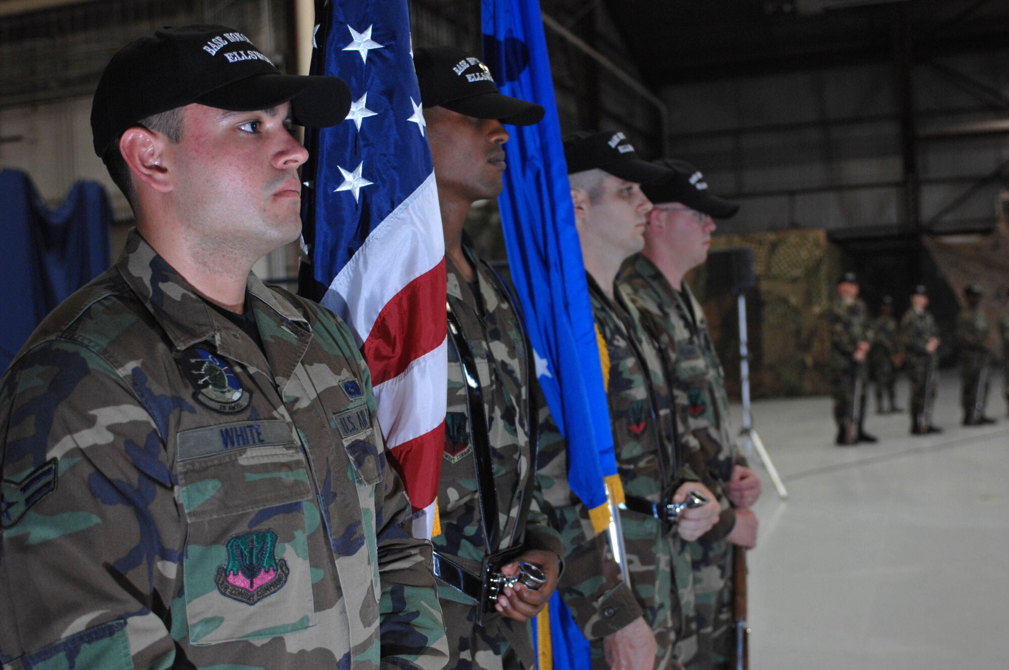 (left) Airman 1st Class Charles White, Ellsworth Honor Guard member, stands ready to perform drill during an honor guard open house here, Sept. 25. The open house showcased skills of the Ellsworth Honor Guard team, educated attendees about honor guard functions and served to recruit new honor guard members. (U.S. Air Force photo by Airman Corey Hook)

