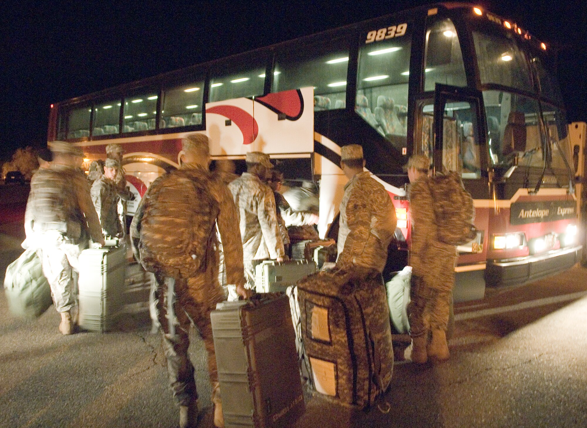 Airmen with the 95th Securty Forces Squadron  load a bus to leave for a deployment to Ali Air Base, Iraq, Sept. 23. This six-month deployment is in support of Operation Iraqi Freedom and their primary duty will be to maintain security.(Air Force photo by Mike Cassidy)