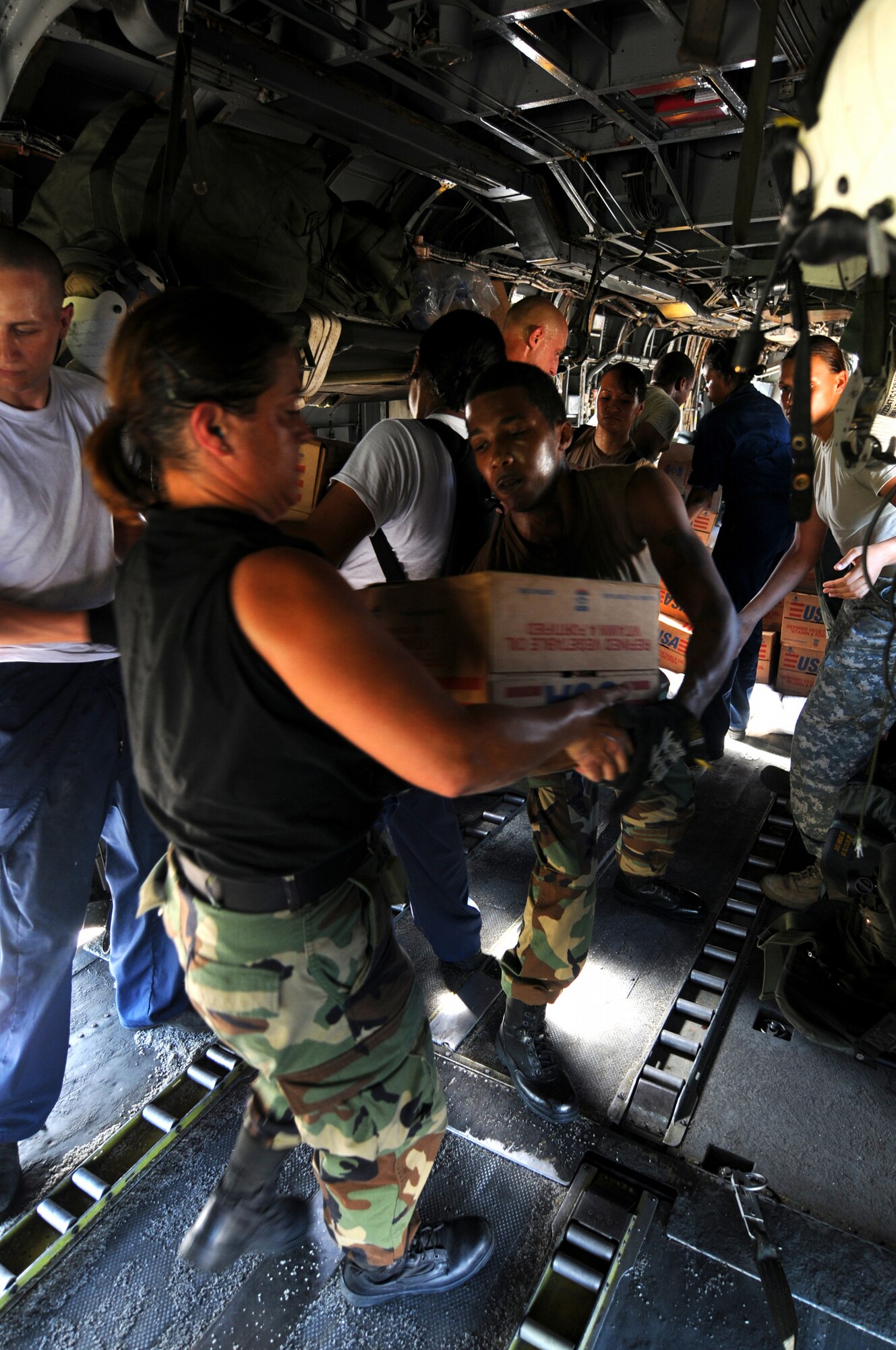 Airmen and Sailors from the amphibious assault ship USS Kearsarge load bags of rice into a CH-53 Sea Stallion helicopter to be delivered to Hurricane stricken communities in Haiti as part of a humanitarian aid/disaster relief mission.  American Contributions to the relief effort were coordinated by the United States Agencies for International Development and it's office of U.S. Foreign Disasters Assistance.  U.S. Navy photo Mass Communication Specialist 3rd Class Christopher Lange (RELEASED)