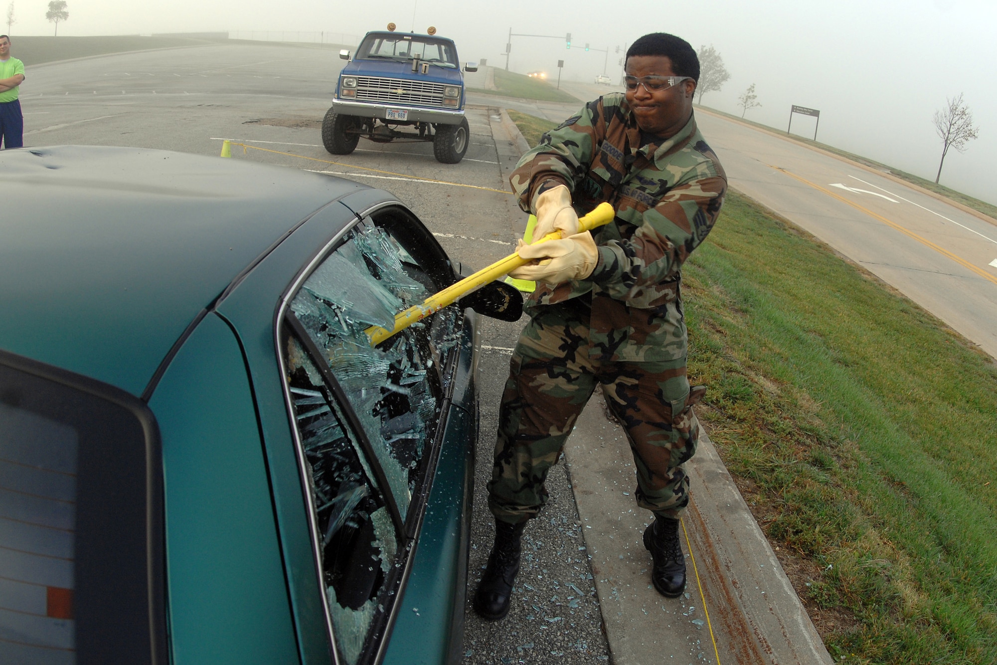 OFFUTT AIR FORCE BASE, Neb. -- Glass shatters as Senior Airman James Goode, 97th Intelligence Squadron, drives a sledgehammer through the back window of the Airman Against Drunk Driving fundraising vehicle as part of the Wingman Day festivities held Sept. 24 at Offutt AFB. (U.S. Air Force Photo By Josh Plueger)