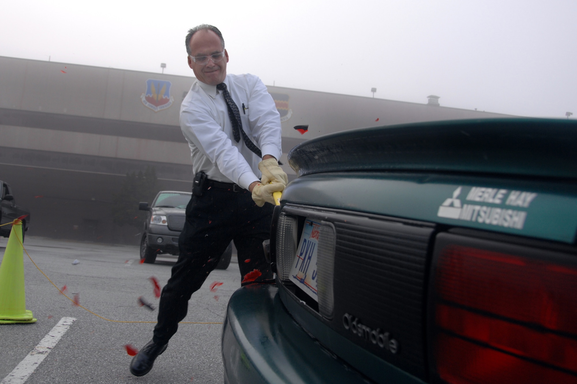 OFFUTT AIR FORCE BASE, Neb. -- John Kundinger, 55th Mission Support Group director, takes out the tail lights of the Airman Against Drunk Driving fundraising vehicle as part of the Wingman Day festivities held Sept. 24 at Offutt AFB.
(U.S. Air Force Photo By Josh Plueger)
