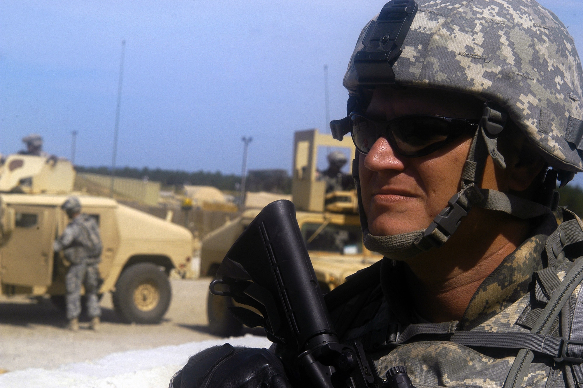 Staff Sgt. Josh Newman peers out at the perimeter of Forward Operating Base Patriot Sept. 24 at Fort Bragg, N.C. Sergeant Newman is assigned to the Nangarhar Provincial Reconstruction Team headed to Afghanistan in November. He is one of only five Air Force noncommissioned officers to ever attend an all-officer Army Signal Corps training course at Fort Gordon, Ga. The training at Fort Gordon was in preparation for the nearly three-month long Combat Skills Training at Fort Bragg and the PRTs deployment to Afghanistan. Sergeant Newman is a satellite communications operator from MacDill Air Force Base, Fla. (U.S. Air Force photo/Master Sgt. Eric M. Grill)