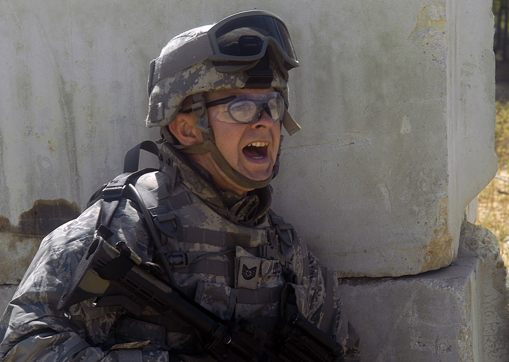 Tech. Sgt. Michael Lovejoy yells directions to fellow Airmen and Soldiers during base defense exercises Sept. 24 at Forward Operating Base Patriot located on Fort Bragg, N.C. Airmen, Sailors and Soldiers are attending Combat Skills Training at Fort Bragg prior to their deployment on 12 different Provincial Reconstruction Teams to Afghanistan in November. Sergeant Lovejoy is from Offutt Air Force Base, Neb. (U.S. Air Force photo/Master Sgt. Eric M. Grill)