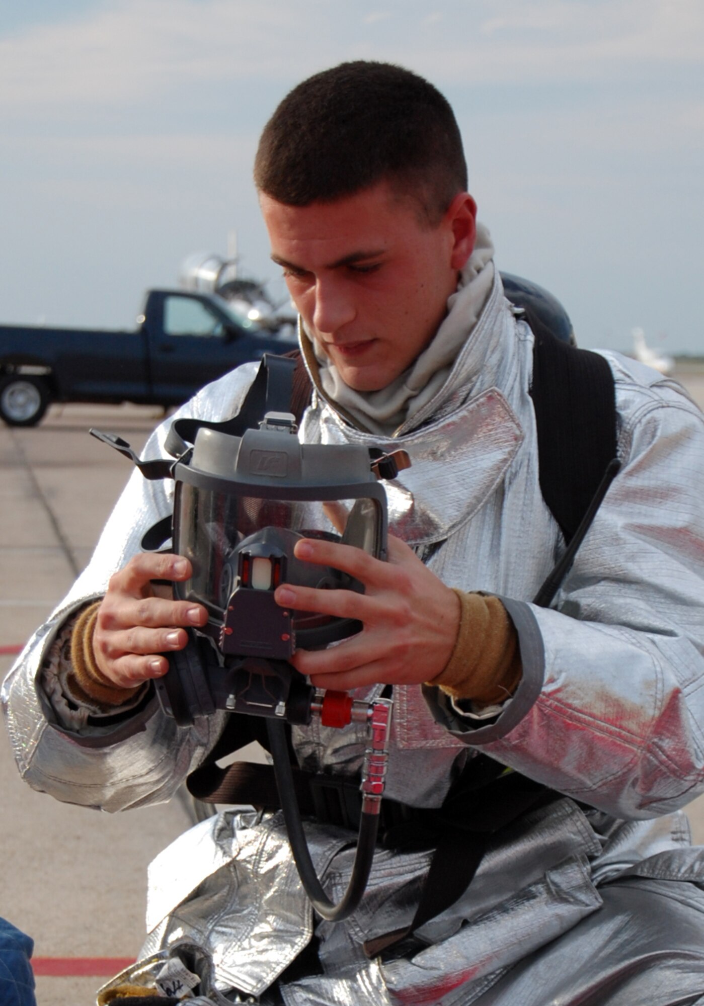 LAUGHLIN AIR FORCE BASE, Texas – Airman Matthew Hall, a firefighter from the 47th Installation Support Squadron, removes his gear after fighting a simulated aircraft fire during an exercise on the flight line here Sept. 24.  (U.S. Air Force photo by Staff Sgt Austin M. May)