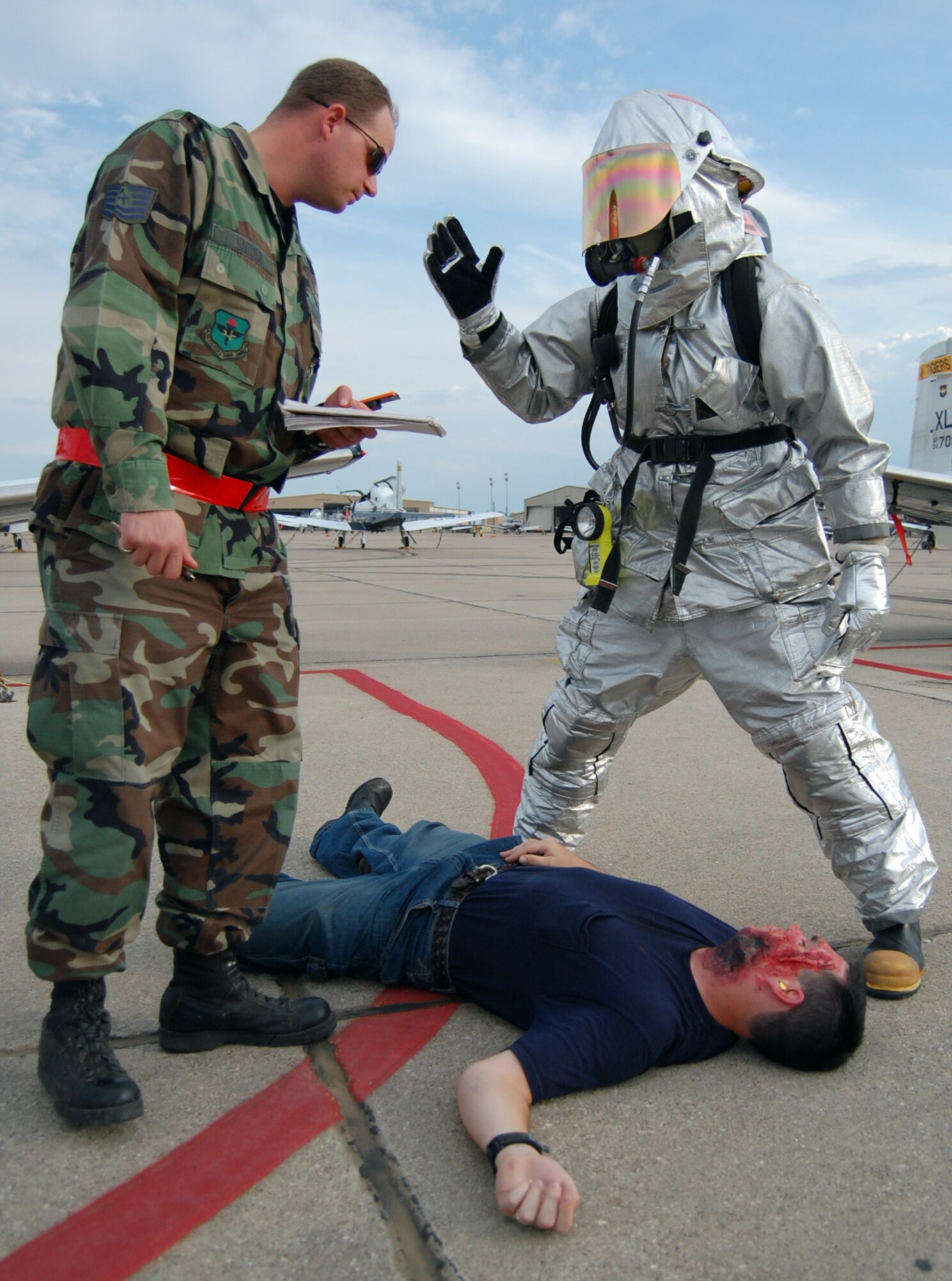 LAUGHLIN AIR FORCE BASE, Texas – A firefighter from the 47th Installation Support Squadron reacts to inputs from Tech. Sgt. Randy Snider, 47th Medical Group Exercise Evaluation Team member, during an exercise here Sept. 24.  Laughlin routinely practices responding to various emergency situations to ensure base personnel are prepared to handle any situation.  (U.S. Air Force photo by Staff Sgt Austin M. May)
