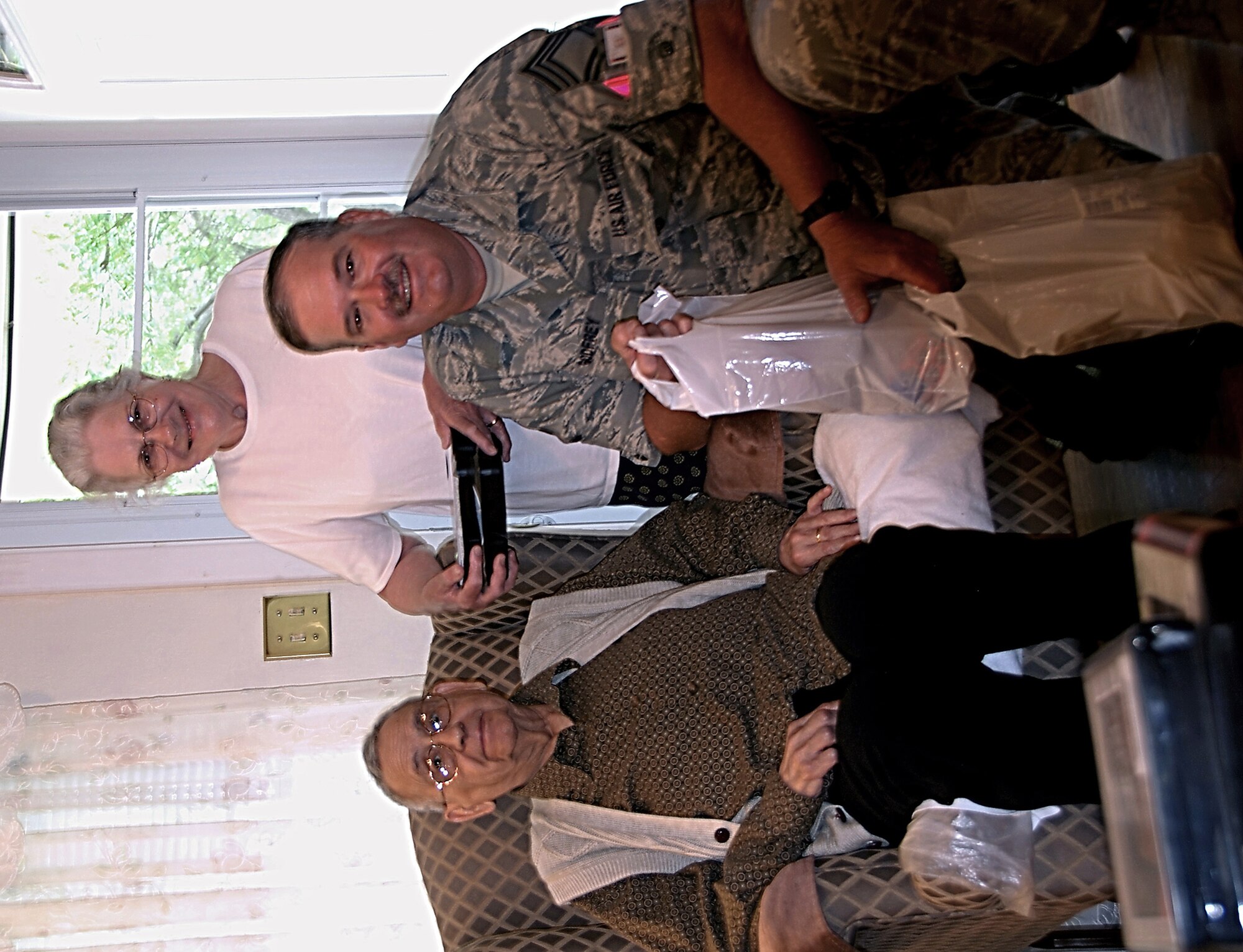Chief Master Sgt. Mark Godfrey, 301st Aircraft Maintenance Squadron, delivers another Meal on Wheels to a familiar face. Chief Godfrey, along with other senior enlisted 301st Fighter Wing members, have been involved in the program for nearly two years. (U.S. Air Force Photo)