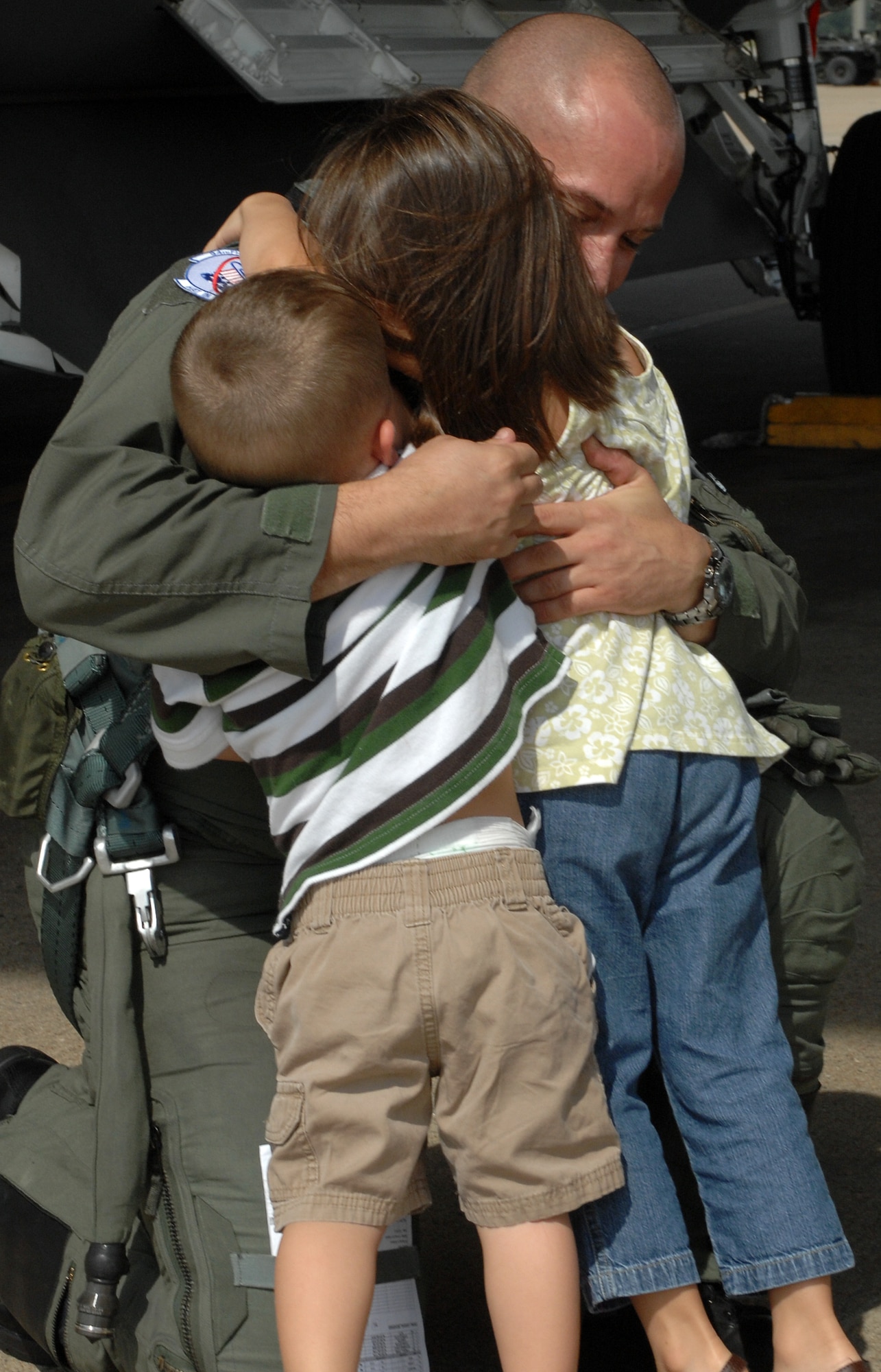 LANGLEY AIR FORCE BASE, Va. – Capt. Brian Stahl, 94th Fighter Squadron pilot, hugs his children, Afton and Wilson, after returning from Combat Archer Sept. 27.  Combat Archer is an air-to-air weapons system evaluation program that allows pilots to test the reliability and effectiveness data of aircraft and missiles.  (U.S. Air Force photo/Airman 1st Class Zachary Wolf)