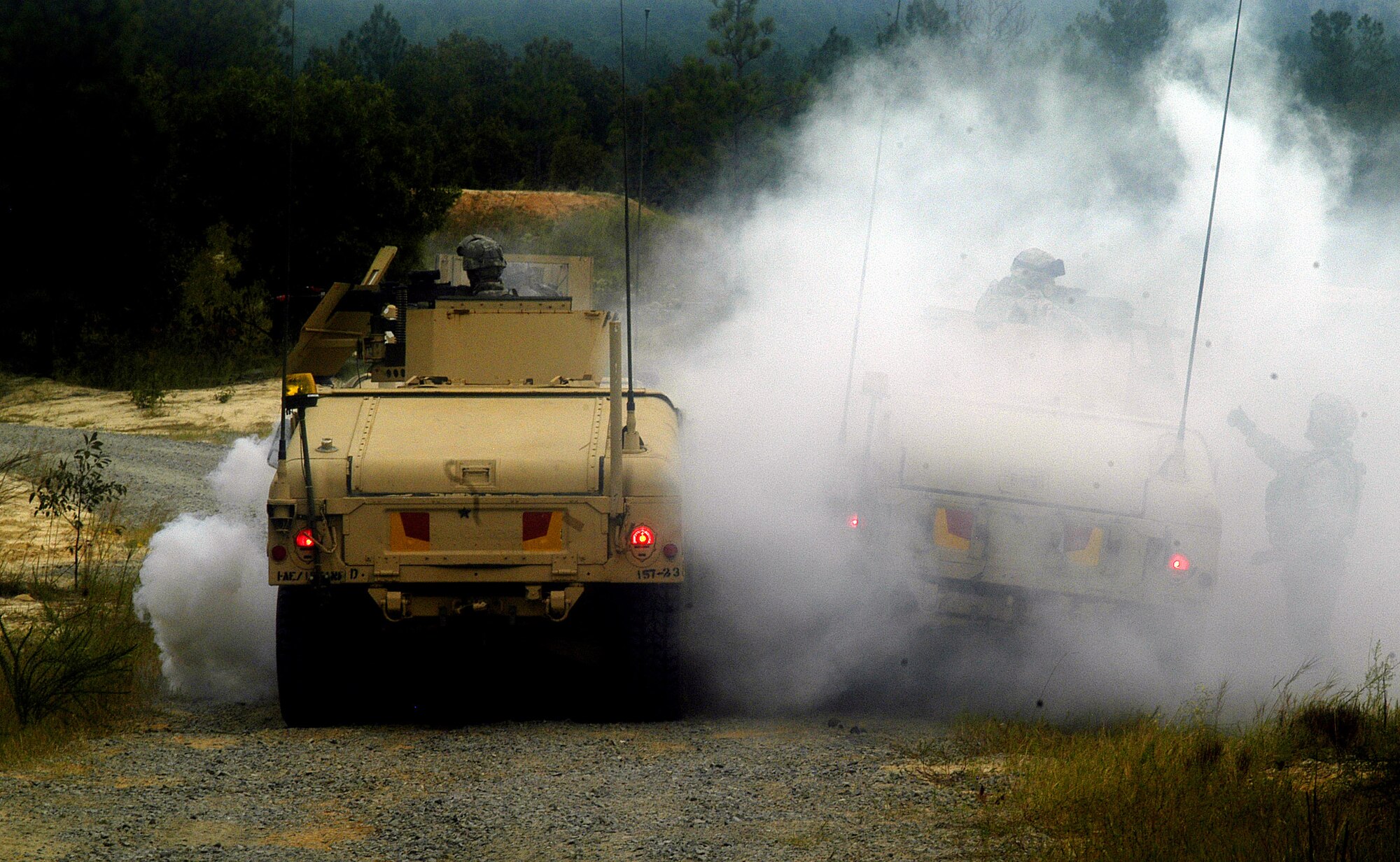 Airmen react to a simulated improvised explosive device attack Sept. 23 at Fort Bragg, N.C. The Aimen, along with Airmen react to a simulated improvised explosive device attack Sept. 23 at Fort Bragg, N.C. The Aimen, along with Sailors and Soldiers are training at Fort Bragg as part of 12 different Provincial Reconstruction Teams headed to different Afghan provinces in November. Some of the skills they learn at Fort Bragg include convoy operations, weapons, counter improvised explosive device tactics, language and cultural training and combat lifesaving skills training. (U.S. Air Force photo/Master Sgt. Eric M. Grill)

