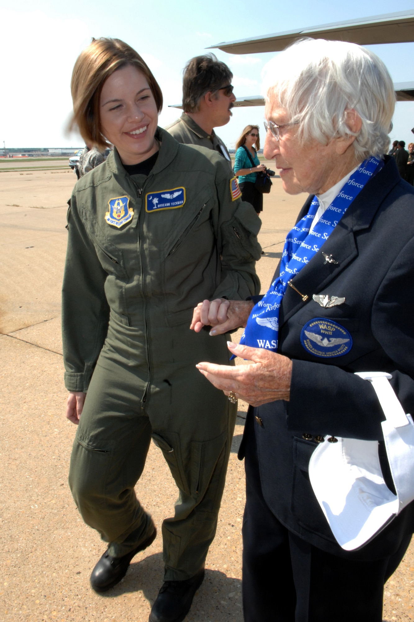 Capt. Roseanne Teckman, a flight nurse with Air Force Reserve Command's 315th Airlift Wing, Charleston Air Force Base, S.C., escorts an original member of the Women Airforce Service Pilots from World War II, during the WASP's "final flight" on an Air Force Reserve C-130. (U.S. Air Force photo/Tech. Sgt. Dawn Price)