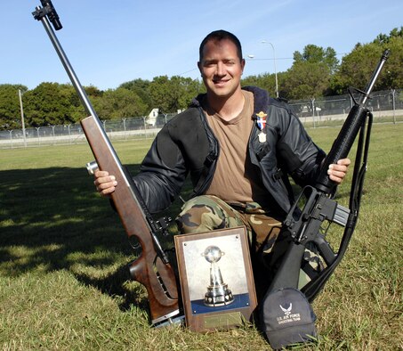 Sergeant Griffin with his competion rifles, Roberts trophy, and bronze medal. (Air Force Photo/Staff Sgt. Josh Nason)