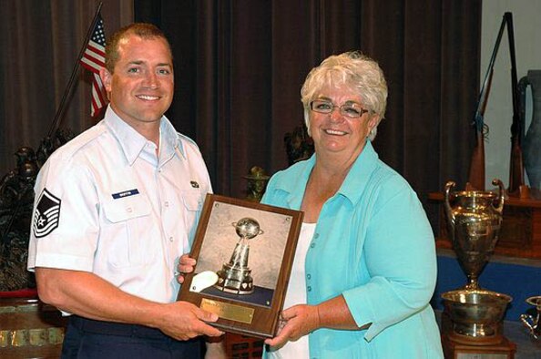 Master Sgt. Griffin receives the Lt. Paul J. Roberts memorial trophy from CMP board member Judith Legerski, at Camp Perry, Ohio. (Courtesy photo)