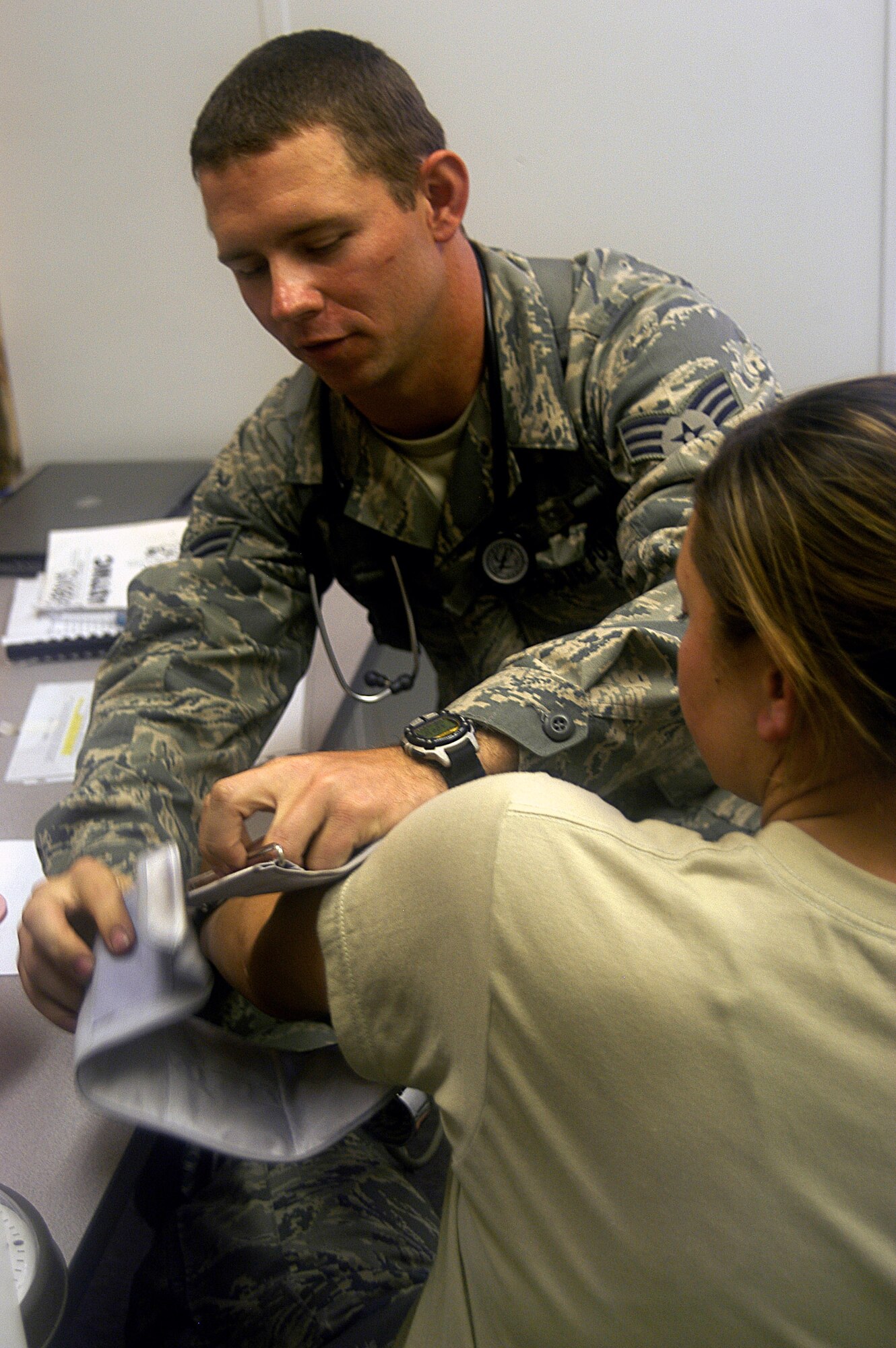 Senior Airman George Williams applies a blood pressure cuff to a patient at a "forward deployed" clinic Sept. 23 at Fort Bragg, N.C. Airman Williams is in Combat Skills Training for an upcoming deployment as part of a Provincial Reconstruction Team to Afghanistan. Airman Williams is an Air Force medic deployed from Keesler Air Force Base, Miss. (U.S. Air Force photo/Master Sgt. Eric M. Grill)
