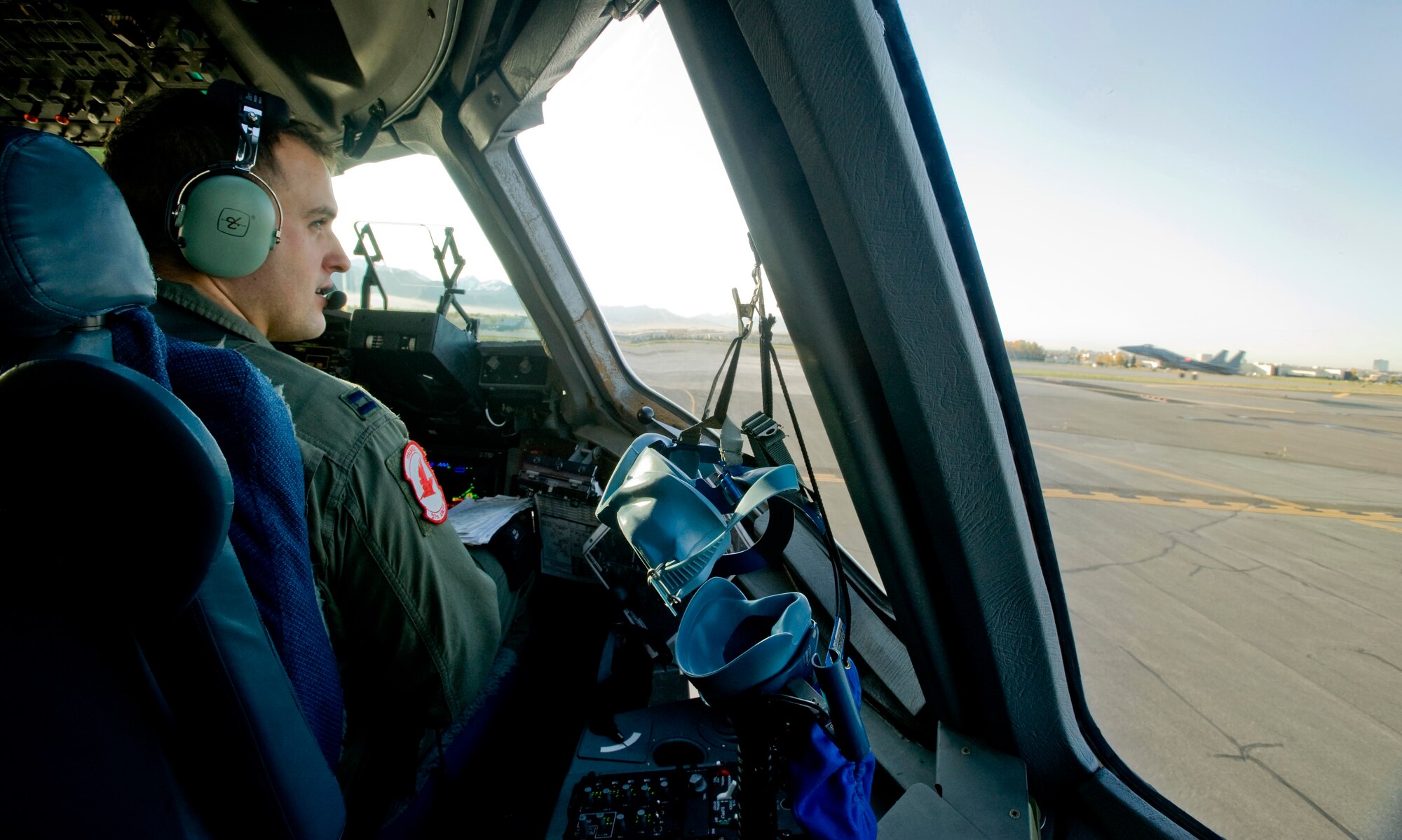 ELMENDORF AIR FORCE BASE, Alaska -- Capt. Dennis Nita, 517th Airlift Squadron, awaits his clearance to take off as an F-15C Eagle comes in for landing Sept. 26. The 517th AS trains daily for cargo and troops drops to prepare for real world contingencies. (U.S. Air Force photo/Senior Airman Jonathan Steffen)