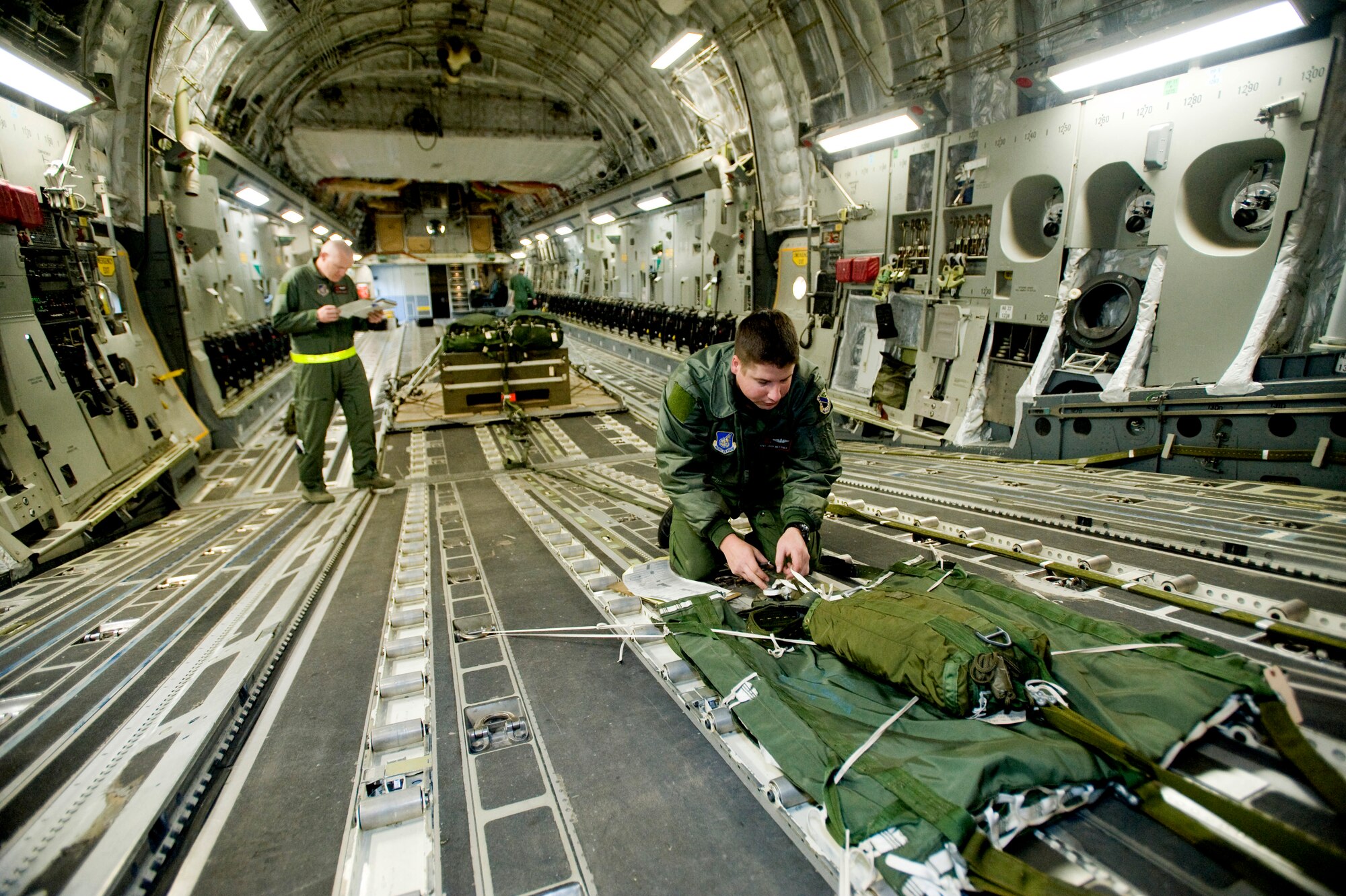 ELMENDORF AIR FORCE BASE, Alaska -- Staff Sgt. John Metzger, 517th Airlift Squadron, inspects the parachute prior to flight Sept. 26. The 517th AS trains daily for cargo and troops drops to prepare for real world contingencies. (U.S. Air Force photo/Senior Airman Jonathan Steffen)
