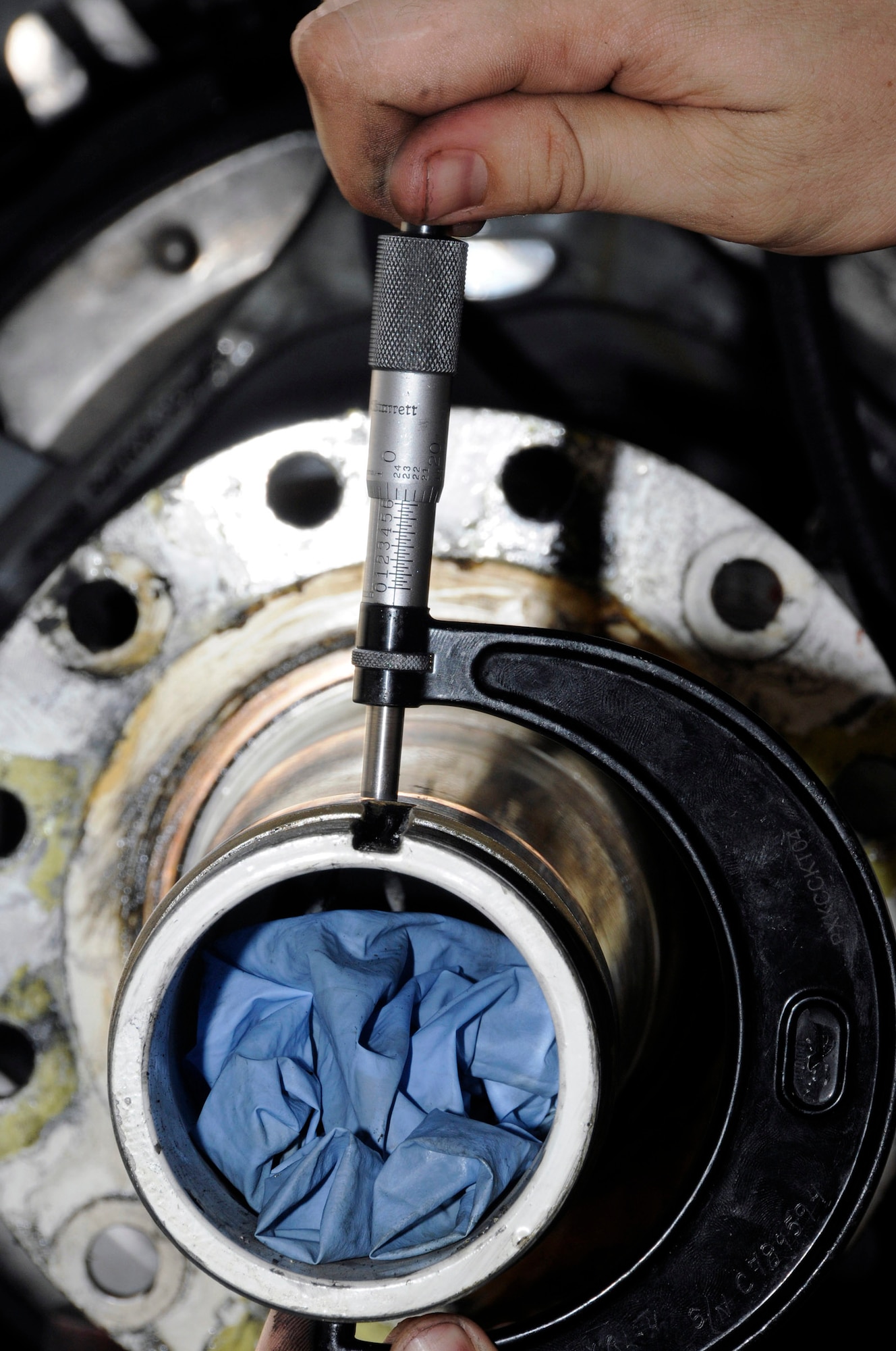 Tech. Sgt. Chris Reiter checks the tolerance on a KC-135 Stratotanker landing gear axle Sept. 28 at an air base in Southwest Asia. The tolerance is checked at both the front and rear to assure it is still within limits. The brake set had to be replaced when a crack in the heat shield was detected during a post-flight inspection. Sergeant Reiter, a native of Farmington, N.M., is deployed from Fairchild Air Force Base, Wash. He is assigned to the 379th Expeditionary Aircraft Maintenance Squadron. (U.S. Air Force photo/Tech. Sgt. Michael Boquette) 
