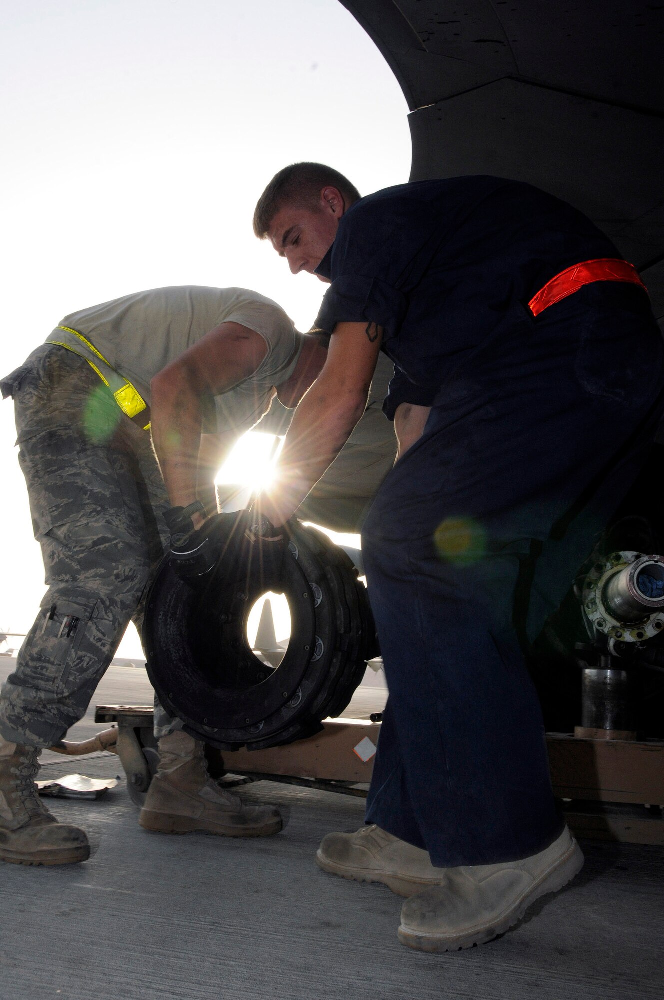 Tech. Sgt. Chris Reiter and Airman 1st Class Ryan McMillen move an unserviceable brake unit from a KC-135 Stratotanker Sept. 28 at an air base in Southwest Asia. The brake set had to be replaced when a crack in the heat shield was detected during a post-flight inspection. Sergeant Reiter, a native of Farmington, N.M., is deployed from Fairchild Air Force Base, Wash. Airman McMillen is from Warsaw, Ill., and deployed from McConnell AFB, Kan. Both are assigned to the 379th Expeditionary Aircraft Maintenance Squadron. (U.S. Air Force photo/Tech. Sgt. Michael Boquette) 
