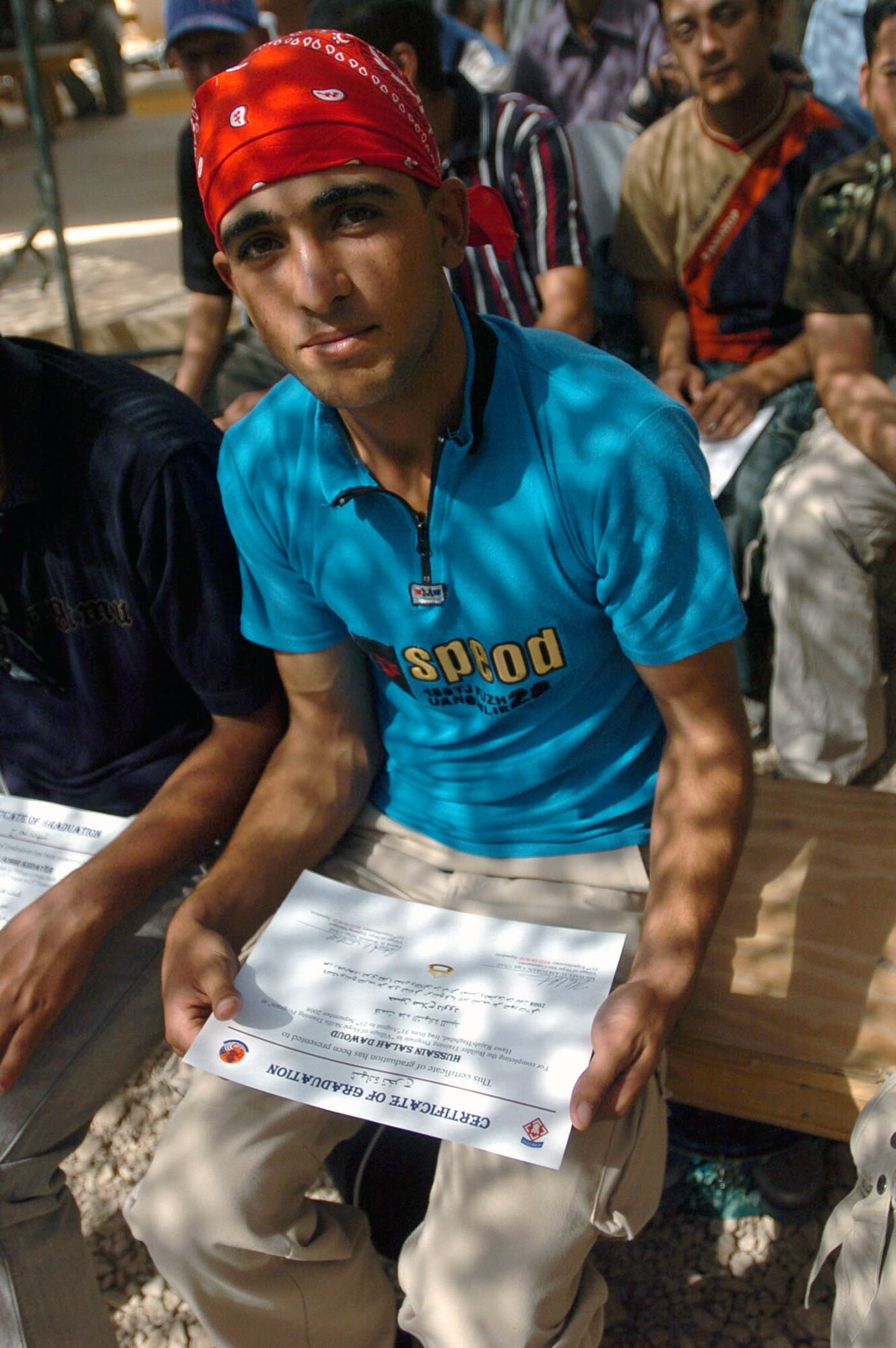 A student sits with his certificate after graduating from the fourth and final class at the Village of Hope training center at Patrol Base Stone, Iraq, Sept. 25. (U.S. Army photo/Pfc. Christopher McKenna)