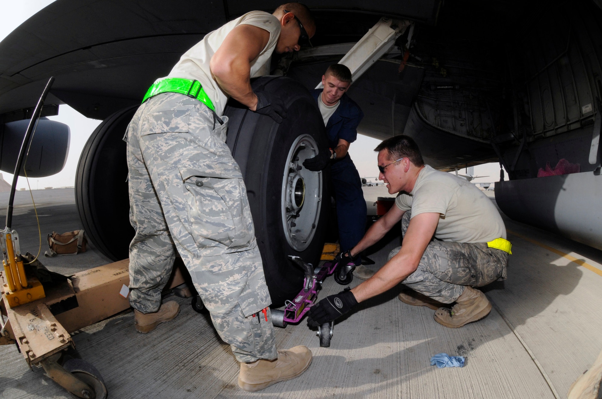 Airman 1st Class James Giesick and Airman 1st Class Ryan McMillen hold a tire while Tech. Sgt. Chris Reiter maneuvers the dolly for removal of a tire on a KC-135 Stratotanker Sept. 28 at an air base in Southwest Asia. The tire needed to be removed and the brake unit replaced after a crack in the heat shield was detected during a post-flight inspection. Sergeant Reiter, a native of Farmington, N.M., is deployed from Fairchild Air Force Base, Wash. Airman Giesick is from San Diego and deployed from Grand Forks AFB, N.D., and Airman McMillen, originally from Warsaw, Ill., is deployed from McConnell AFB, Kan. All are assigned to the 340th Aircraft Maintenance Unit. (U.S. Air Force photo/Tech. Sgt. Michael Boquette) 

