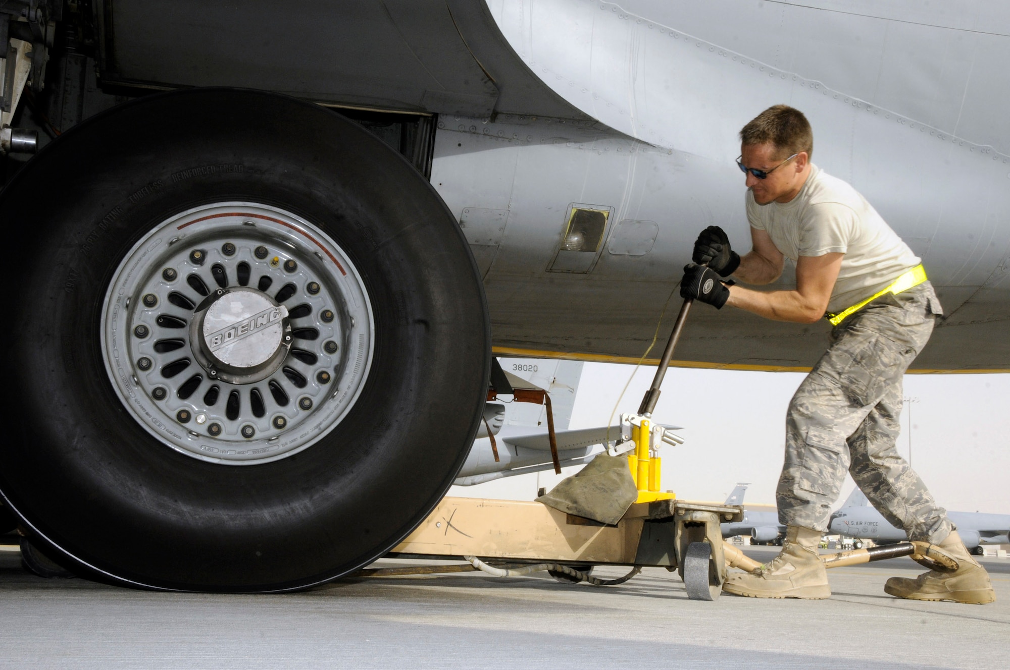 Tech. Sgt. Chris Reiter cranks on a jack lifting more than 300,000 pounds of a KC-135 Stratotanker Sept. 28 at an air base in Southwest Asia. The tire needed to be removed and the brake unit replaced after a crack in the heat shield was detected during a post-flight inspection. Sergeant Reiter is assigned to the 340th Aircraft Maintenance Unit. He is a native of Farmington, N.M., is deployed from Fairchild Air Force Base, Wash. (U.S. Air Force photo/Tech. Sgt. Michael Boquette) 
