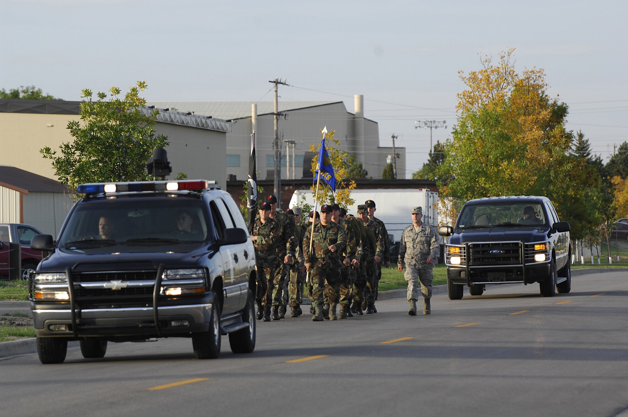 MINOT AIR FORCE BASE, N.D. — Members from the 5th Aircraft Maintenance Squadron participate in the POW/MIA Ruck March here Sept. 25. The march was organized as a joint effort between the 5th Bomb Wing and 91st Missile Wing to pay tribute to prisoners of war and service members missing in action. To recognize and honor their sacrifice, members from both wings marched around base carrying military packs and the POW/MIA flag from early morning until a special retreat ceremony at 4 p.m.  (U.S. Air Force photo by Airman 1st Class Jesse Lopez) 

