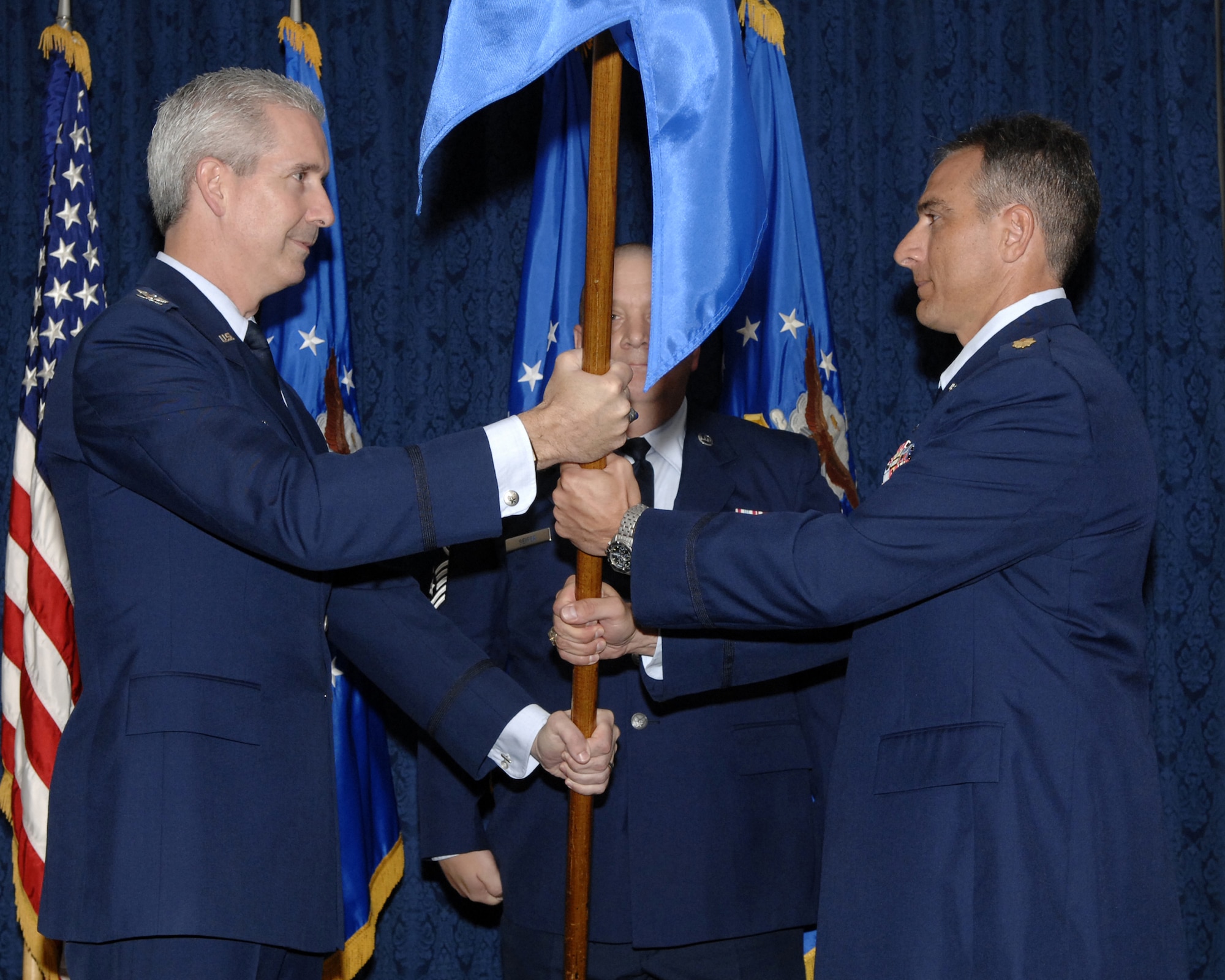 Col. Jon A. Roop, 11th Wing commander, passes the guidon to Maj. Jason Kobylski, 11th Comptroller Squadron commander, Oct. 23 during an assumption of command ceremony in the Bolling Clubs. Previously a directorate of the 11th Wing, the new squadron is 32 members strong and will be relocating from building 5681 to building P-20, room 240. The relocation is planned for late October to early November. (U.S. Air Force photo by Staff Sgt. Raymond Mills)