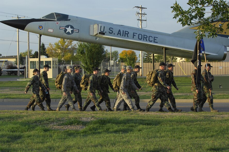 MINOT AIR FORCE BASE, N.D. — Members from the 5th Aircraft Maintenance Squadron participate in the POW/MIA Ruck March here Sept. 25. The march was organized as a joint effort between the 5th Bomb Wing and 91st Missile Wing to pay tribute to prisoners of war and service members missing in action. To recognize and honor their sacrifice, members from both wings marched around base carrying military packs and the POW/MIA flag from early morning until a special retreat ceremony at 4 p.m.  (U.S. Air Force photo by Airman 1st Class Jesse Lopez) 