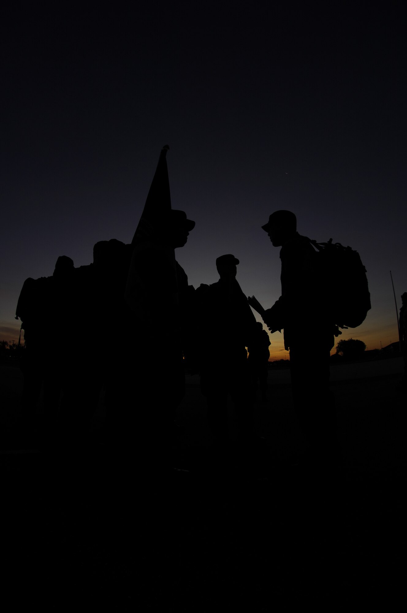MINOT AIR FORCE BASE, N.D. -- Members from the 791st Security Forces Squadron, 5th Operations Support Squadron, and 5th Force Support Squadron prepare to lead off the POW/MIA Ruck March here Sept. 25. The march was organized as a joint effort between the 5th Bomb Wing and 91st Missile Wing to pay tribute to prisoners of war and service members missing in action. To recognize and honor their sacrifice, members from both wings marched around base carrying military packs and the POW/MIA flag from early morning until a special retreat ceremony at 4 p.m. (U.S. Air Force photo by Tech. Sgt. Lee A. Osberry Jr.)  

 

