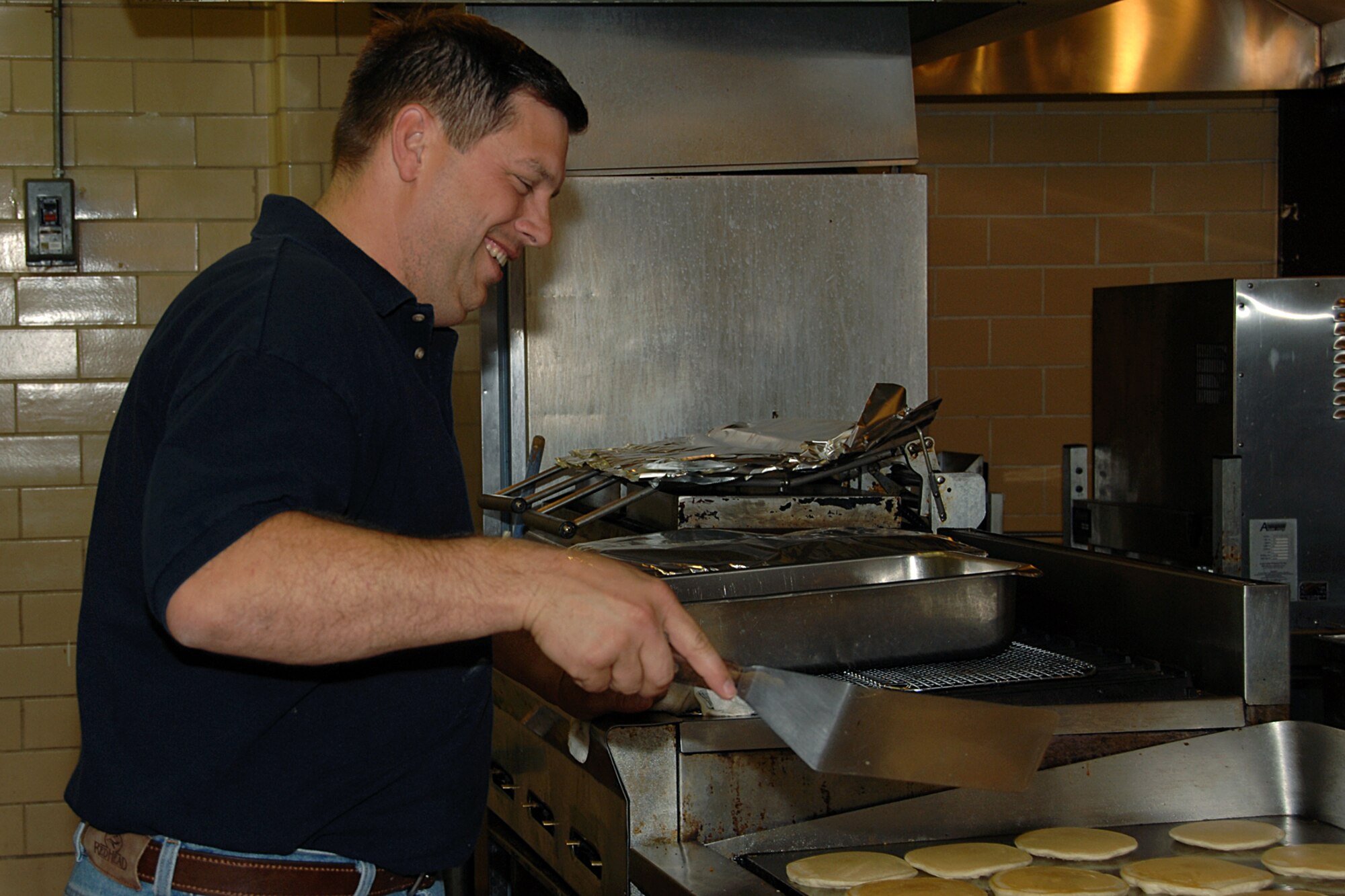 OFFUTT AIR FORCE BASE, Neb. -- Chief Master Sgt. Bob Schwanke of U.S. Strategic Command flips pancakes in preparation for the Offutt Chief’s Group Pancake Feed at the Patriot Club Sept. 24. The breakfast included scrambled eggs with and without sausage, orange juice, coffee and all the pancakes you could eat.  (U.S. Air Force Photo By Charles Haymond)

