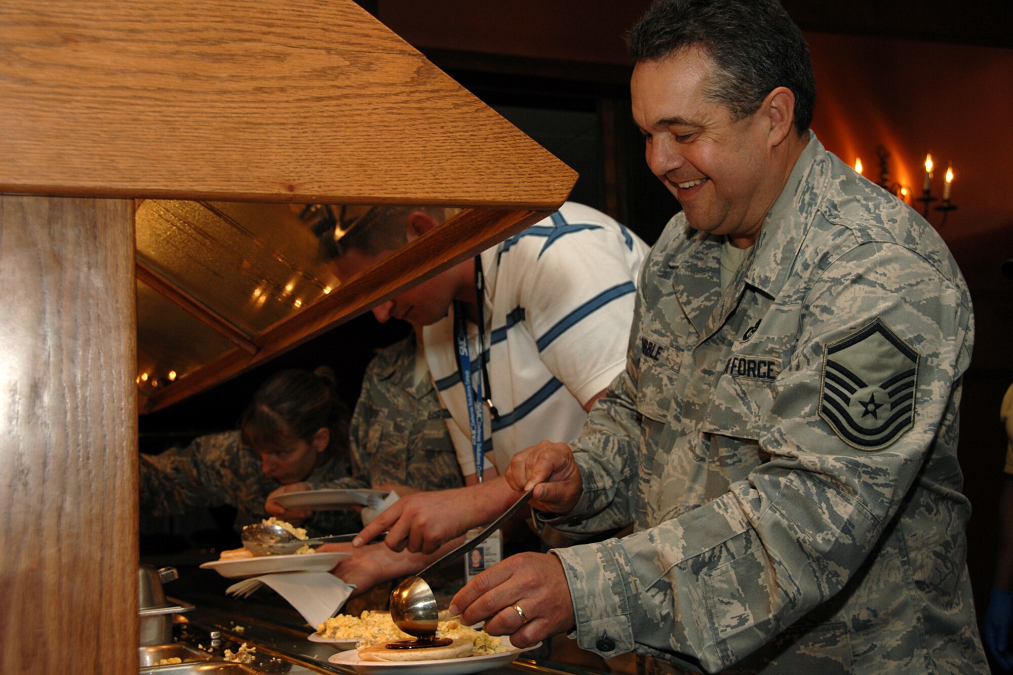 OFFUTT AIR FORCE BASE, Neb. -- Master Sgt. Doug Dribble of the Air Force Weather Agency drips syrup onto his pancakes during the Offutt Chief’s Group Pancake Feed held at the Patriot Club Sept. 24. The pancake feed is a biannual event and proceeds support numerous Team Offutt programs including the Airman Leadership School and the Chief’s Sharp Troop award. (U.S. Air Force Photo By Charles Haymond)

