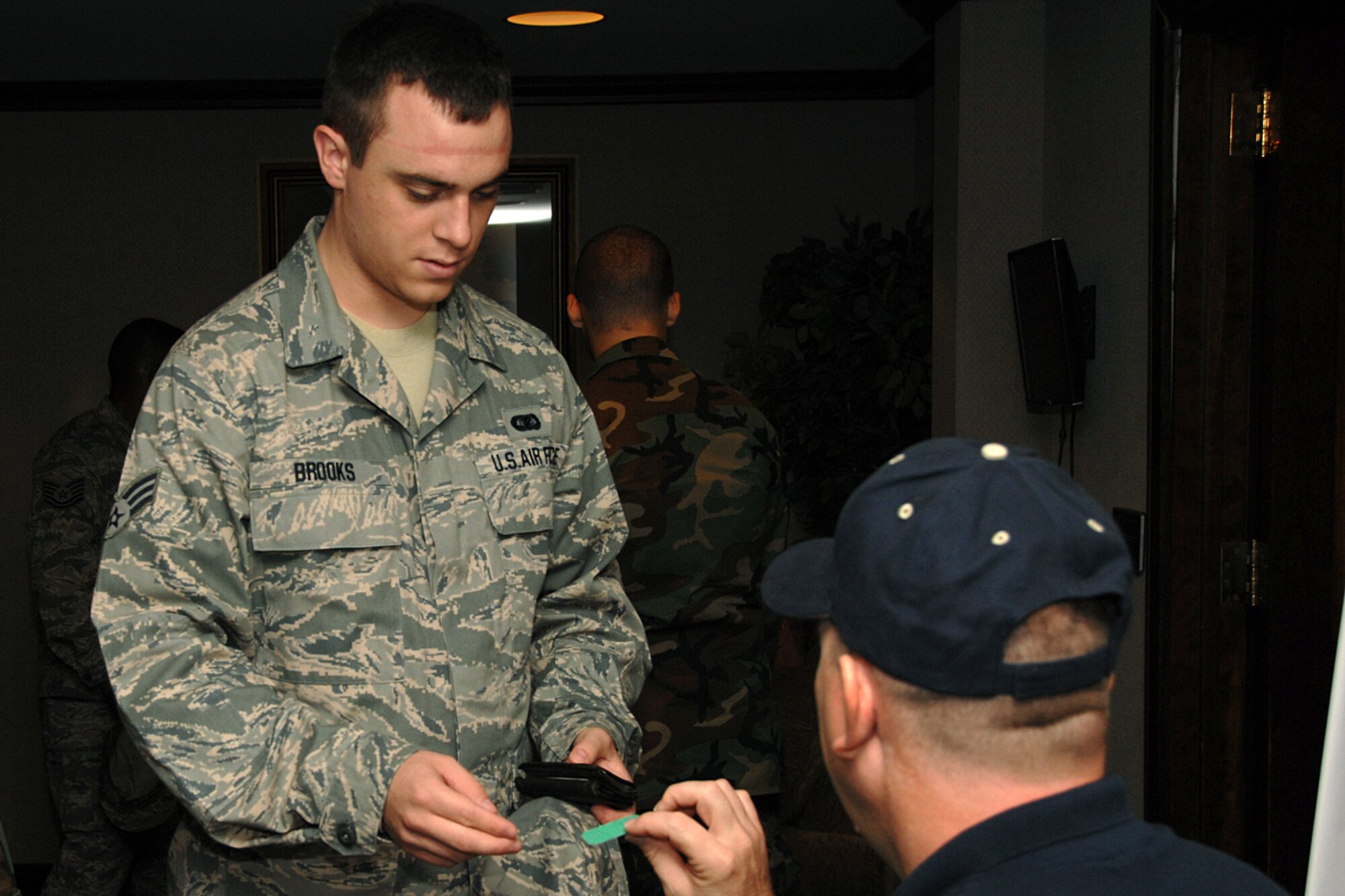 OFFUTT AIR FORCE BASE, Neb. -- Senior Airman Steven Brooks, 55th Mission Support Group, hands his ticket to Chief Master Sgt. David Debates of U.S. Strategic Command for the Offutt Chief’s Group Pancake Feed at Patriot Club Sept. 24. The pancake feed is a biannual event and proceeds support numerous Team Offutt programs including the Airman Leadership School and the Chief’s Sharp Troop award.  (U.S. Air Force Photo By Charles Haymond)