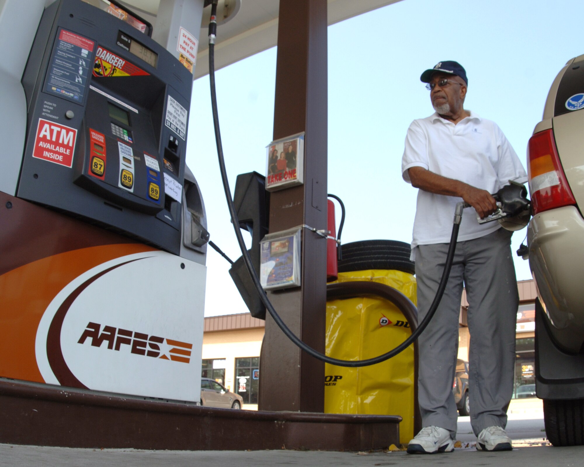 Retired Senior Master Sgt. Caldwell Anthony fills the tank of his SUV Sept. 22 at Offutt’s main gas station.  As the price of a gallon of milk rivals that of a gallon of gas, many people like Sergeant Anthony are looking for ways to get a few more miles out of a tank of gas. (U.S. Air Force Photo By Tech. Sgt. Rhonda Moraski)