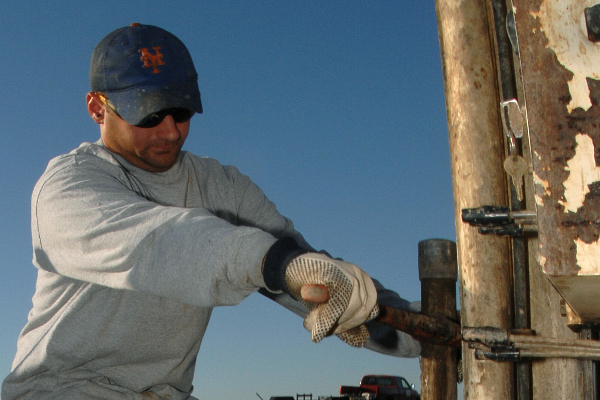 Chris Companogne, a contractor with Environmental Priority Services, drills a steel rod into a groundwater plume at Offutt Sept. 9.  The rod, used as part of an environmental cleanup effort called bio-sparging, will be used to inject the plume with a liquid which feeds microorganisms already present in the groundwater.  The microorganisms ultimately breakdown contaminants in the plume.  Since 2005, environmental contractors have injected approximately 4.5 million gallons of biostimulant into groundwater plumes around the base as part of Offutt’s Environmental Restoration Program. (U.S. Air Force Photo By Charles Haymond)