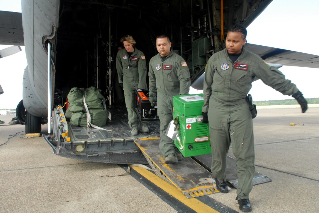 LITTLE ROCK AIR FORCE BASE, Arkansas --908th AES members (from right) Tech. Sgt. Melinda Ford, Master Sgt. Apen Phillips, and Senior Airman Angela Burton unload medical equipment from a C-130 after a combined effort from the 61st Airlift Squadon and the 908th Aeromedical Evacuation Squadron, Maxwell AFB, Ala., to transport medical patients from Beaumont to Lackland AFB, Texas, in preparation for Hurricane Ike's landfall in southern Texas. (U.S. Air Force photo by Staff Sgt. Chris Willis) (RELEASED)
