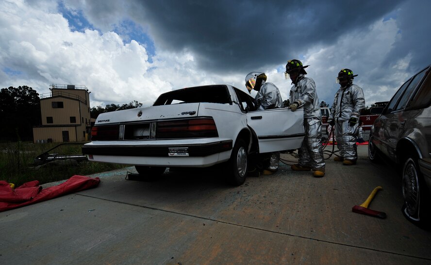 MOODY AIR FORCE BASE, Ga. -- 23rd Civil Engineer Squadron firefighters remove the door on a training vehicle with the Jaws of Life here Sept. 11. By removing the entire door, the firefighters are able to safely remove victims. (U.S. Air Force photo by Senior Airman Elizabeth Rissmiller)
