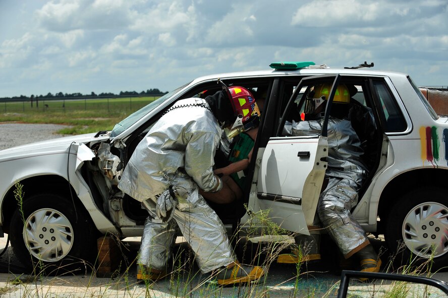 MOODY AIR FORCE BASE, Ga. -- 23rd Civil Engineer Squadron firefighters put a Kendrick Extrication Device (KED) on Rescue Randy, a training mannequin, before removing it from a vehicle during training here Sept. 11. The KED is used to immobilize a patient that has spine or neck injuries before they are transported. (U.S. Air Force photo by Senior Airman Elizabeth Rissmiller)
