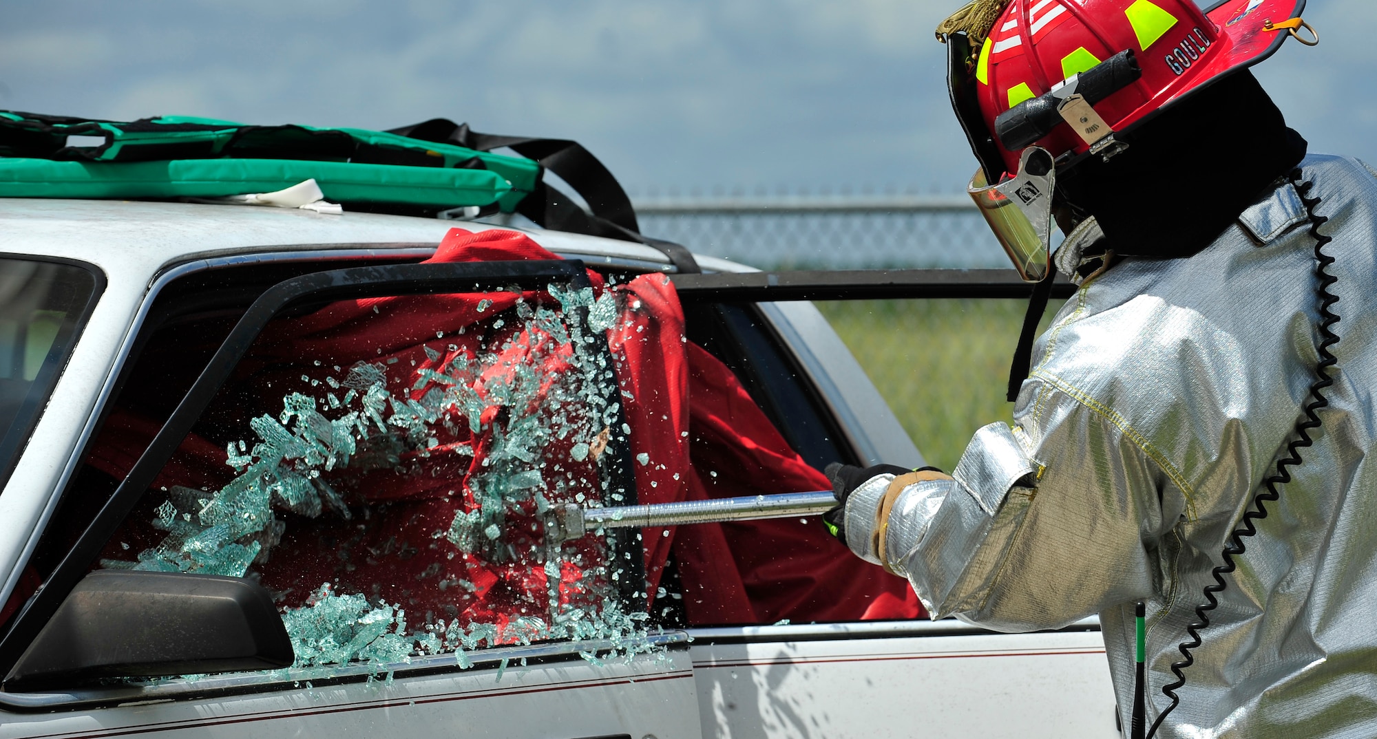 MOODY AIR FORCE BASE, Ga. -- Staff Sgt. Darren Gould, 23rd Civil Engineer Squadron fire protection crew chief, breaks the window of a vehicle with a Haligan bar during training here Sept. 11. The fire department conducts extrication training monthly. (U.S. Air Force photo by Senior Airman Elizabeth Rissmiller)