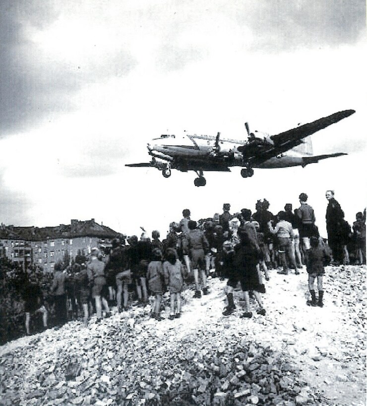 A C-54 Skymaster flies over Western Berlin to deliver supplies to those in need. The Allied Forces started flying over Berlin after the former Soviet Union cut off ground supply routes. (Courtesy photo)