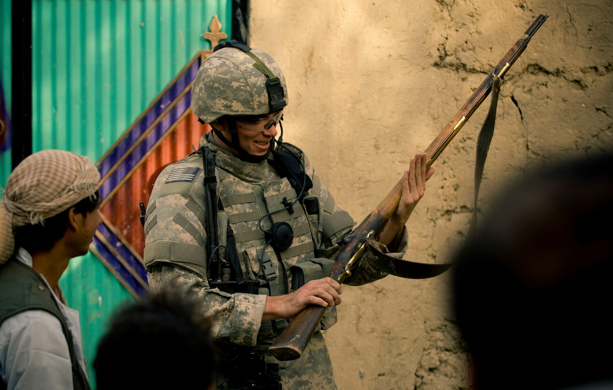Afghanistan -- A villager shows an Airman his hunting rifle.  Allowing an American to admire his rifle -- his primary means for hunting -- shows the trust local Afghans have for their coalition benefactors. (U.S. Air Force photo by Staff Sgt. Samuel Morse/Released)