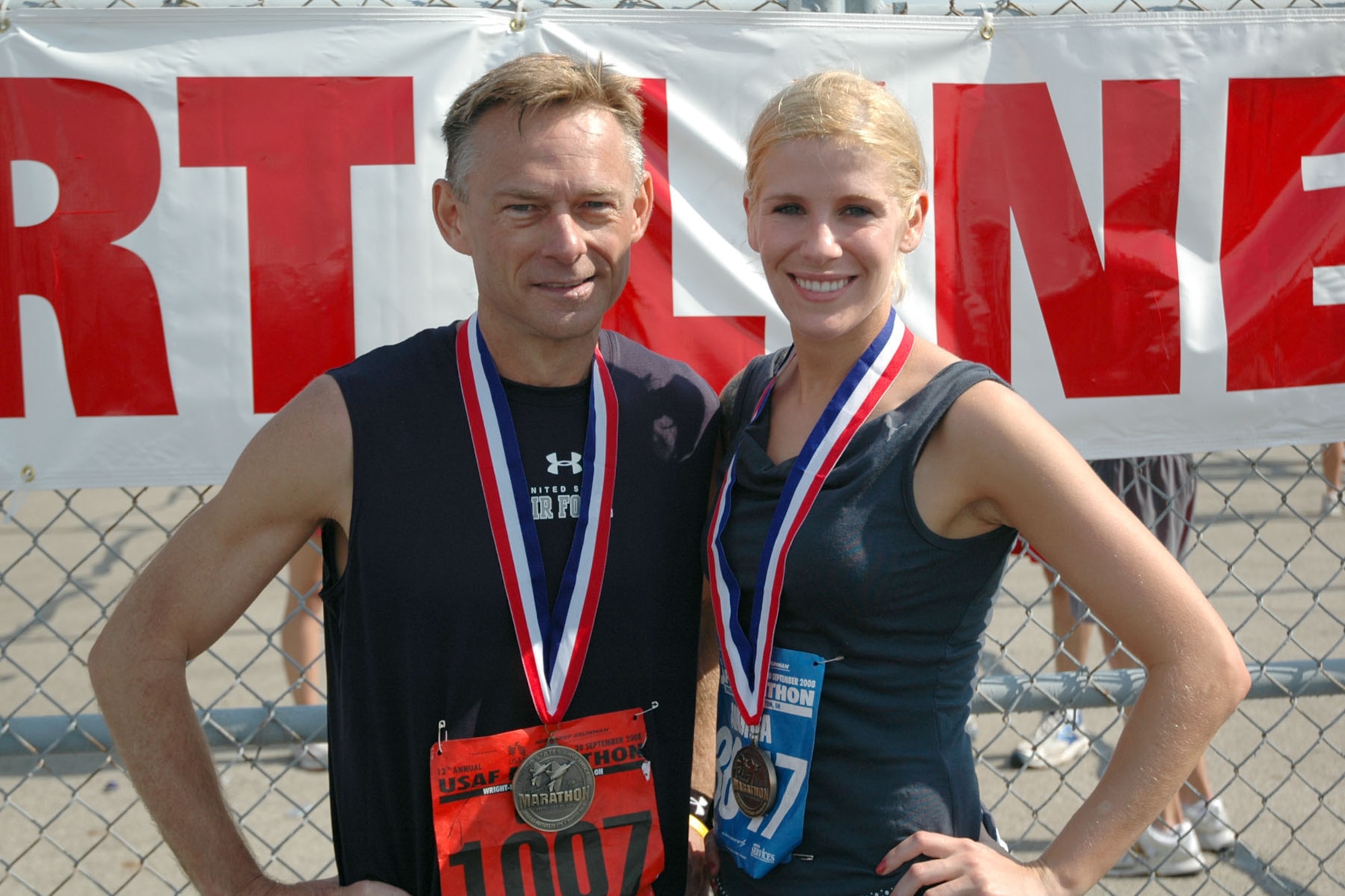 Senior Airman Andria J. Allmond, 512th Airlift Wing, participated in the half-marathon portion of Air Force Marathon activities Sept. 18 to 20 at Wright Patterson Air Force Base, Ohio. She finished the 13.1 miles with a time of 1 hour and 44 minutes, ranking her at 229th out of about 2,500 competitors and 8th in her age group of 25 to 29. Pictured with her following the run is Chief Master Sgt. Gregory W. Koenig, from Hill Air Force Base, Utah, who inspired Airman Allmond to participate in the event and mentored her during the training phase. He ran the full marathon in 3 hours, 42 minutes. (U.S. Air Force photo/Submitted photo)