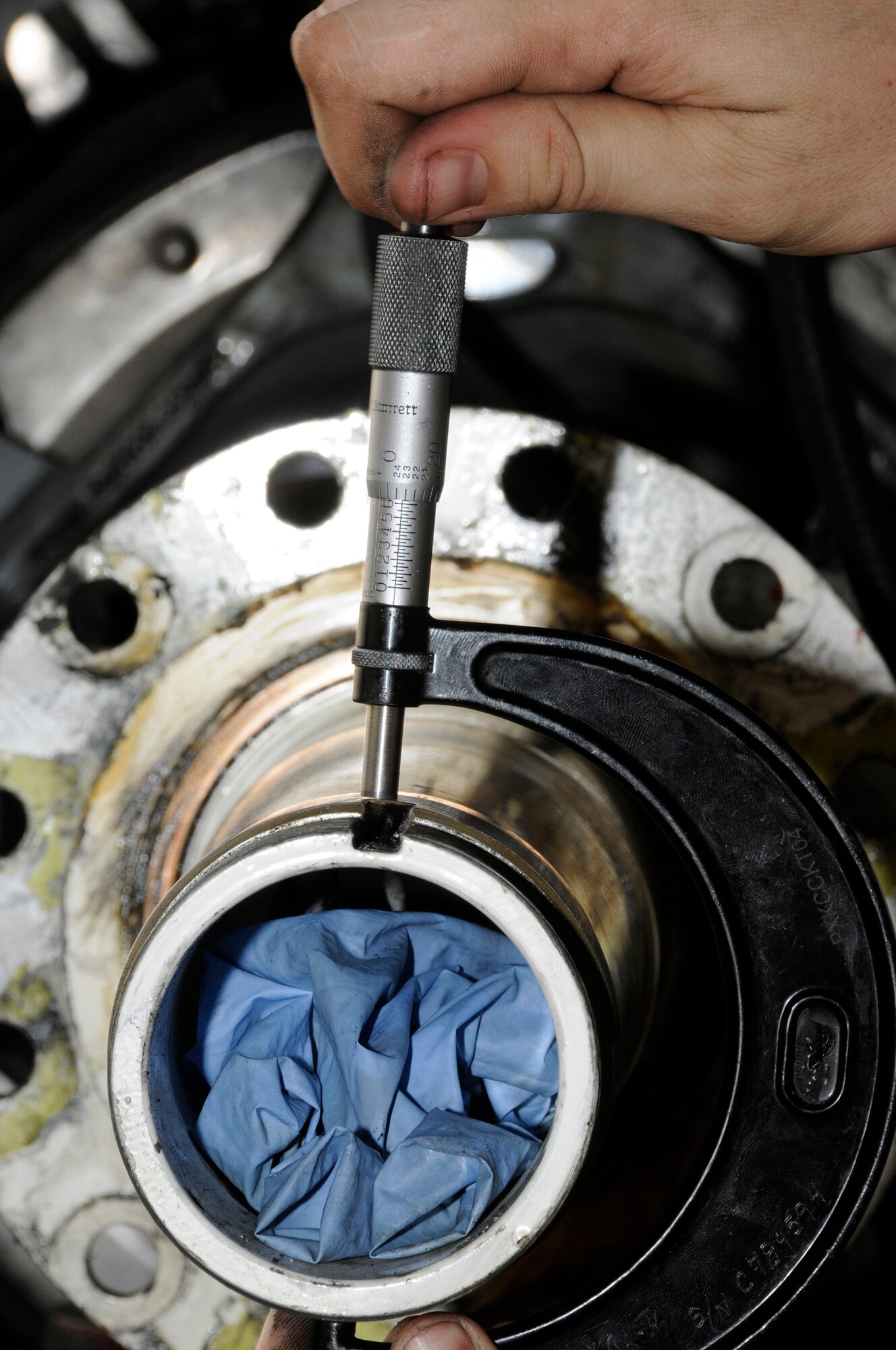 Tech. Sgt. Chris Reiter, 379th Expeditionary Aircraft Maintenance Squadron, 340th Aircraft Maintenance Unit, checks tolerance on a KC-135 landing gear axle Sept. 28, 2008, at an undisclosed air base in Southwest Asia.  The tolerance is checked at both the front and rear to assure it is still within limits.  The brake set had to be replaced when a crack in the heat shield was detected during a post-flight inspection.  Sergeant Reiter, a native of Farmington, N.M., is deployed from Fairchild Air Force Base, Wash., in support of Operations Iraqi and Enduring Freedom and Joint Task Force-Horn of Africa.  (U.S. Air Force photo by Tech. Sgt. Michael Boquette/Released)