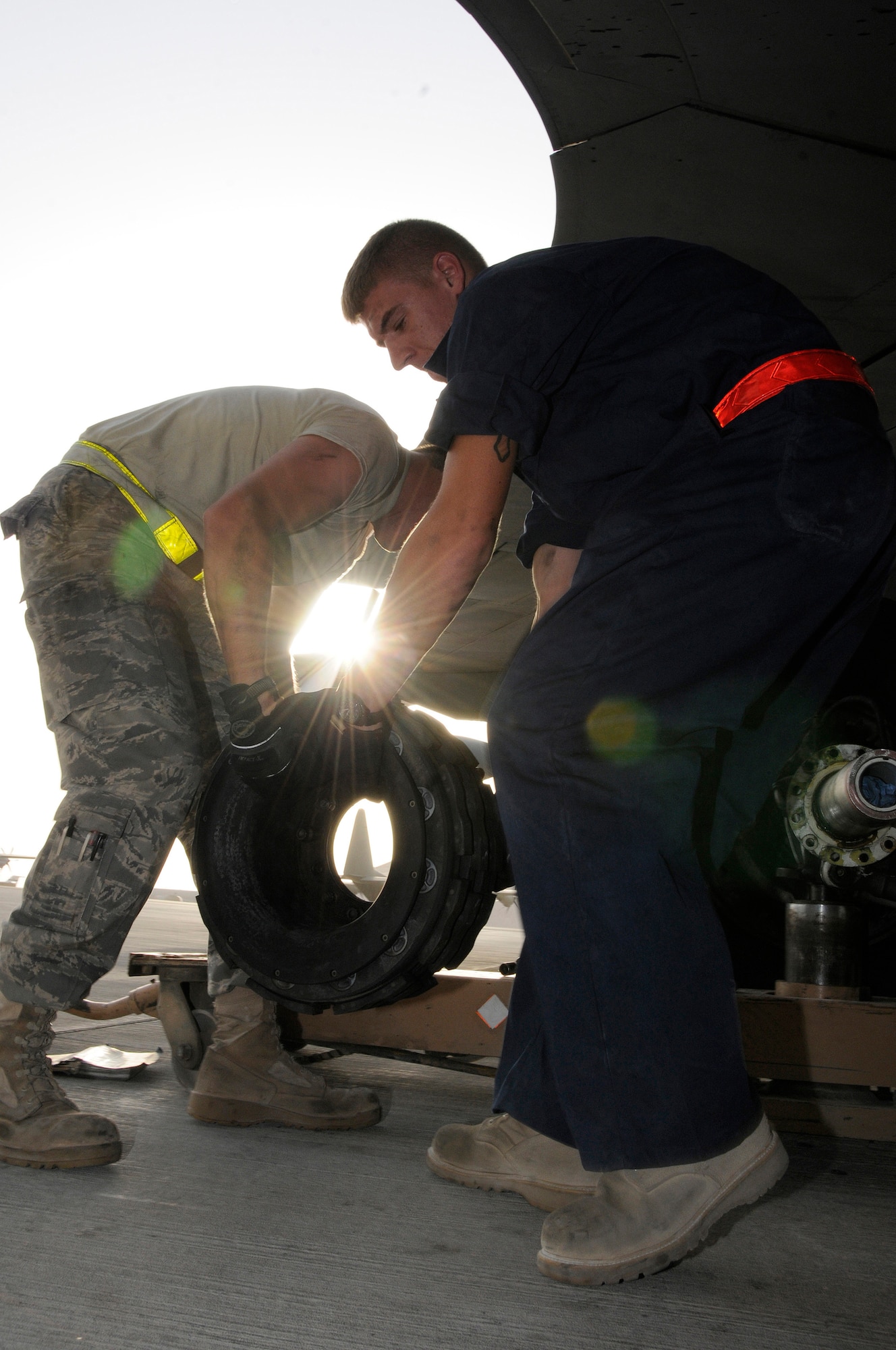 Tech. Sgt. Chris Reiter and Airman 1st Class Ryan McMillen, 379th Expeditionary Aircraft Maintenance Squadron, 340th Aircraft Maintenance Unit, move an unserviceable brake unit from a KC-135 aircraft Sept. 28, 2008, at an undisclosed air base in Southwest Asia.  The brake set had to be replaced when a crack in the heat shield was detected during a post-flight inspection.  Sergeant Reiter, a native of Farmington, N.M., is deployed from Fairchild Air Force Base, Wash.  Airman McMillen, hailing from Warsaw, Ill., is deployed from McConnell AFB, Kan.  Both are deployed here in support of Operations Iraqi and Enduring Freedom and Joint Task Force-Horn of Africa.  (U.S. Air Force photo by Tech. Sgt. Michael Boquette/Released)