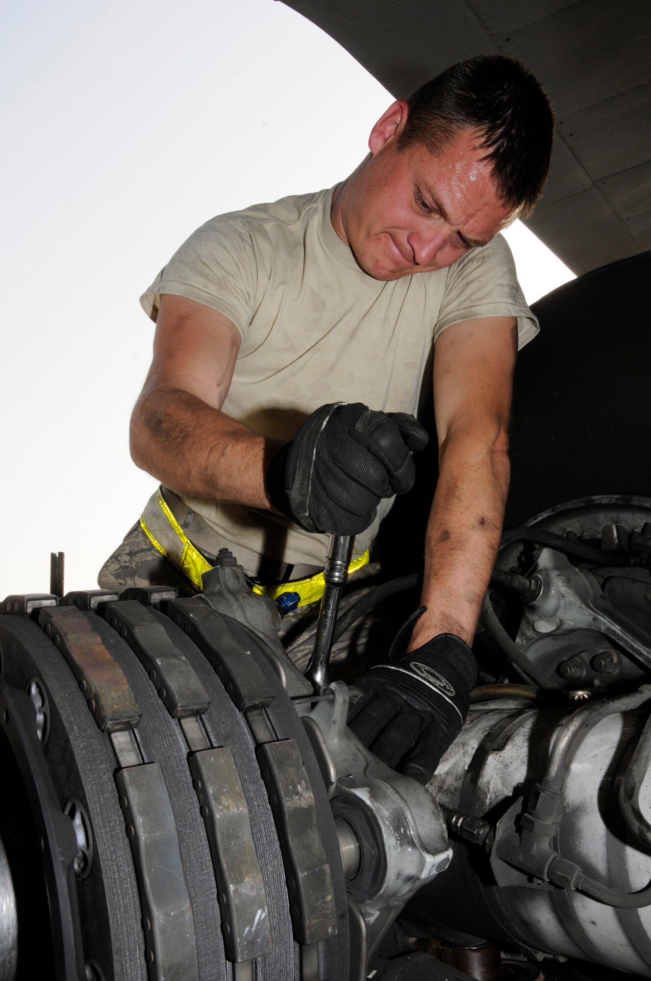 Tech. Sgt. Chris Reiter, 379th Expeditionary Aircraft Maintenance Squadron, 340th Aircraft Maintenance Unit, muscles up to break loose the bolts holding an unserviceable brake unit on a KC-135 aircraft Sept. 28, 2008, at an undisclosed air base in Southwest Asia.  The brake set had to be replaced when a crack in the heat shield was detected during a post-flight inspection.  Sergeant Reiter, a native of Farmington, N.M., is deployed from Fairchild Air Force Base, Wash., in support of Operations Iraqi and Enduring Freedom and Joint Task Force-Horn of Africa.  (U.S. Air Force photo by Tech. Sgt. Michael Boquette/Released)