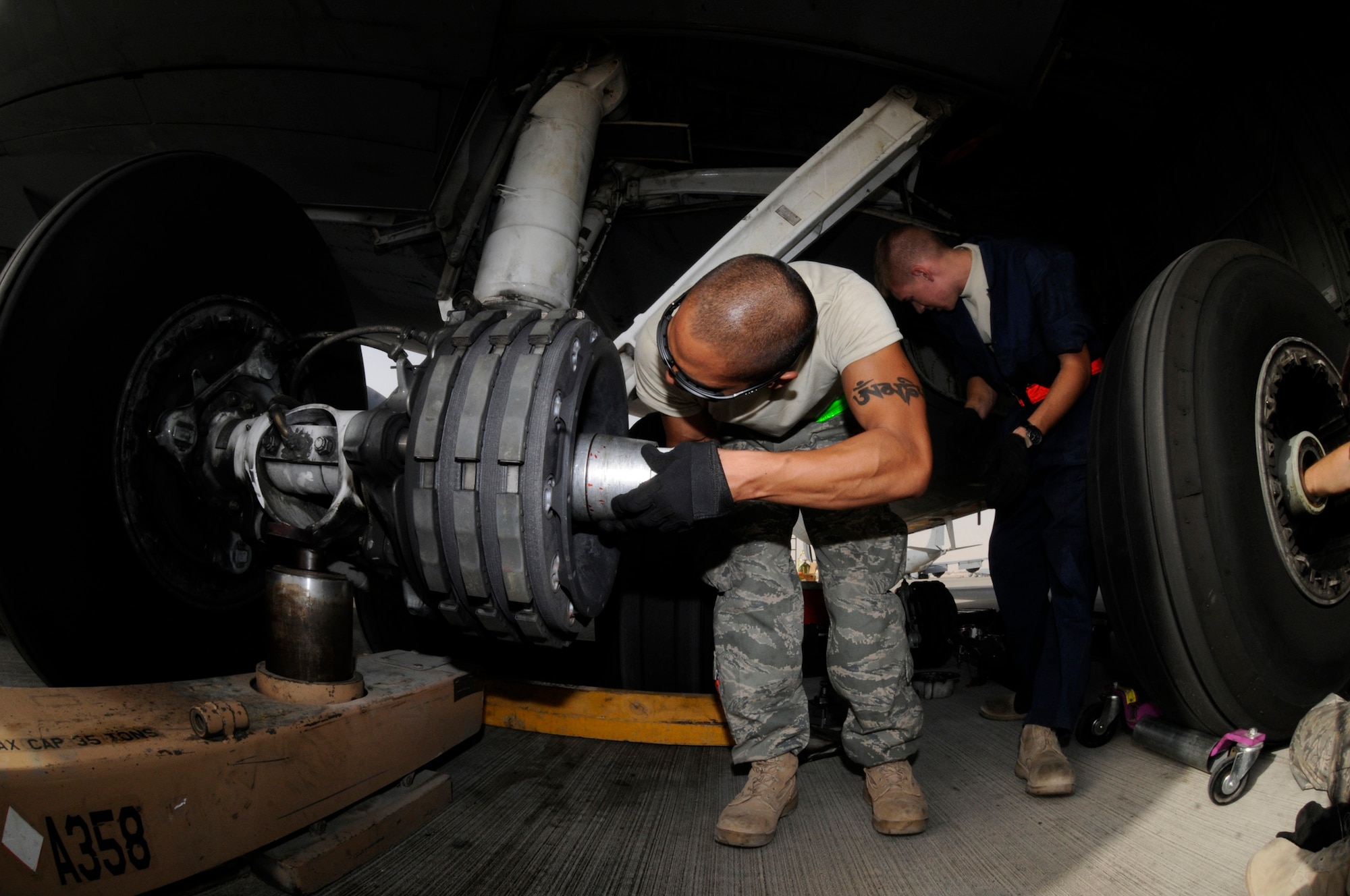 Airman 1st Class James Giesick, 379th Expeditionary Aircraft Maintenance Squadron, 340th Aircraft Maintenance Unit, slides a protective boot on to a KC-135 landing gear axle before removing an unserviceable brake unit Sept. 28, 2008, at an undisclosed air base in Southwest Asia. The tire needs to be removed and the brake unit replaced after a crack in the heat shield was detected during a post-flight inspection.  Airman Giesick, a native of San Diego, Calif., is deployed from Grand Forks Air Force Base, N.D., in support of Operations Iraqi and Enduring Freedom and Joint Task Force-Horn of Africa.  (U.S. Air Force photo by Tech. Sgt. Michael Boquette/Released)