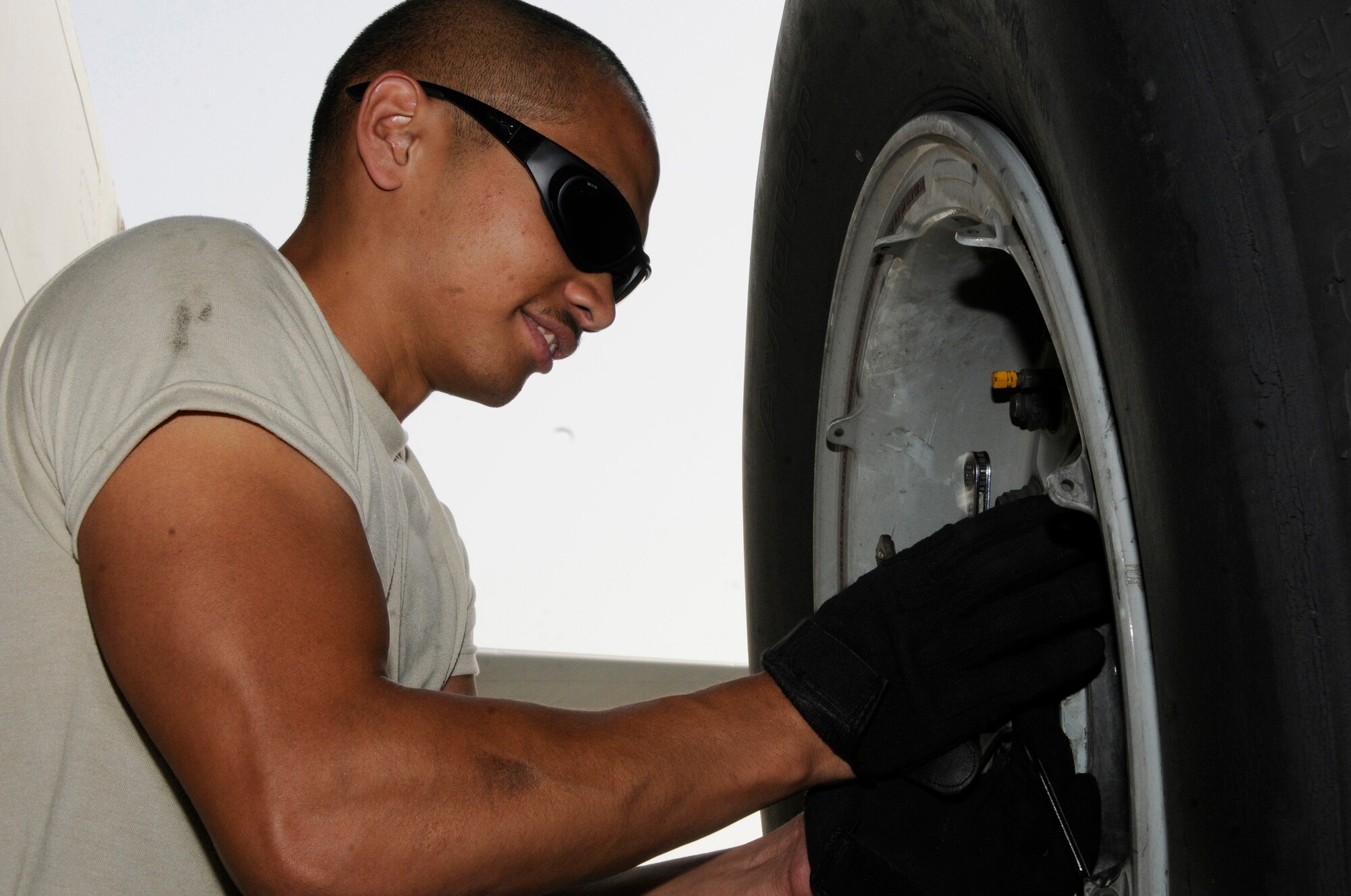 Airman 1st Class James Giesick, 379th Expeditionary Aircraft Maintenance Squadron, 340th Aircraft Maintenance Unit, removes the dust cover on a KC-135 wheel Sept. 28, 2008, at an undisclosed air base in Southwest Asia.  The tire needs to be removed and the brake unit replaced after a crack in the heat shield was detected during a post-flight inspection.  Airman Giesick, a native of San Diego, Calif., is deployed from Grand Forks Air Force Base, N.D, supporting Operations Iraqi and Enduring Freedom and Joint Task Force-Horn of Africa.  (U.S. Air Force photo by Tech. Sgt. Michael Boquette/Released)