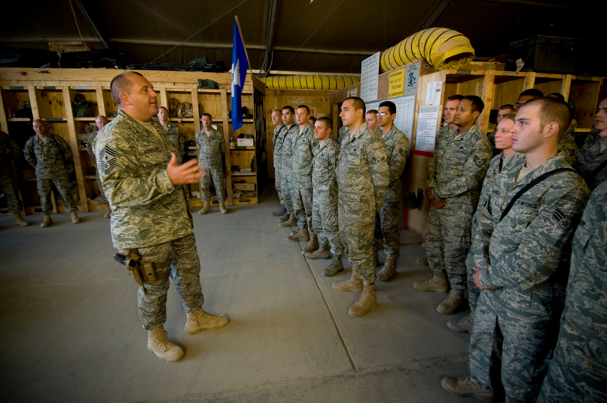 BAGRAM AIR FIELD, Afghanistan -- Chief Master Sgt. Scott Dearduff, U.S. Air Forces Central command chief master sergeant, talks to the Airmen of the 455th Expeditionary Maintenance Group here Sept. 25. Chief Dearduff concluded his speech and the day of touring by reciting the Airman?s Creed with the group. (U.S. Air Force photo by Staff Sgt. Samuel Morse/Released)