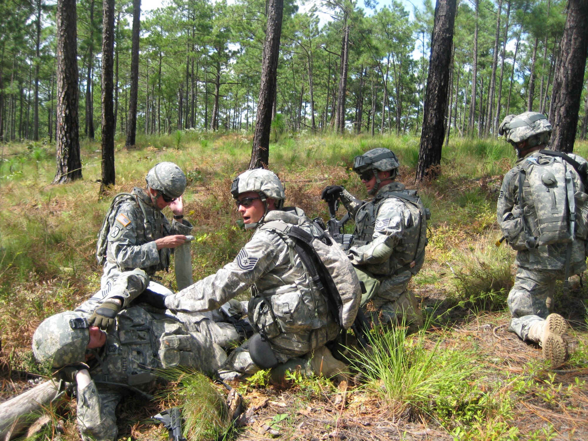 Tech. Sgt. Arthur Sawyer, a member of the Provincial Reconstruction Team deploying to Nangarhar Province, calls for additional assistance during a simulated combat medical scenario during PRT training at Fort Bragg, N.C., Sept. 14.  Sergeant Sawyer, deployed from Shaw Air Force Base, S.C., is one of more than 175 Airmen training alongside Soldiers and Sailors in preparation to deploy with the joint PRTs.  (Courtesy photo)

