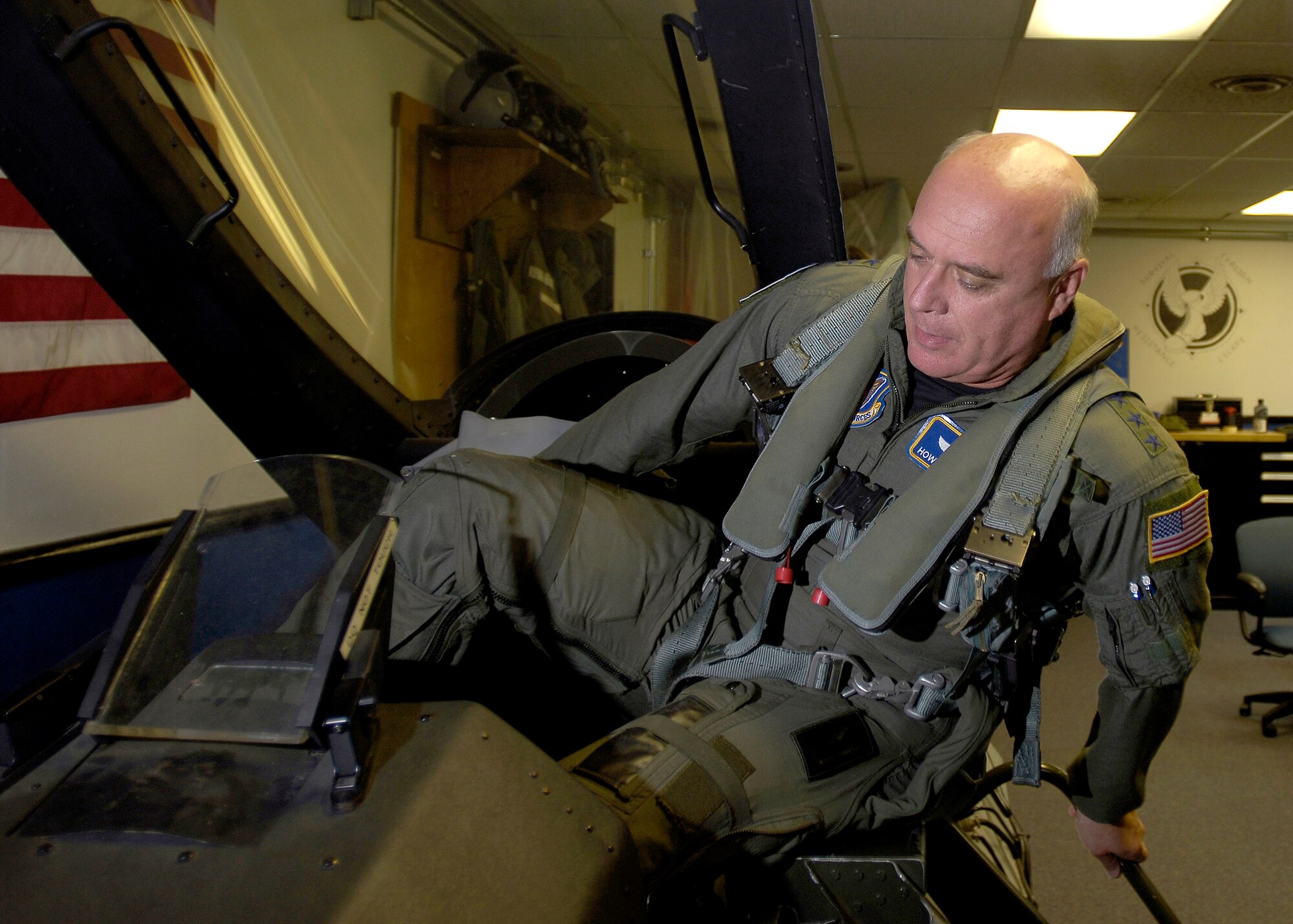MISAWA AIR BASE, Japan -- Gen. Carrol H. "Howie" Chandler, Pacific Air Forces commander, climbs into the training cockpit during egress training prior to his flight Sept. 25, 2008. While here, General Chandler thanked the 35th Fighter Wing for all their work. (U.S. Air Force photo by Senior Airman Chad Strohmeyer)