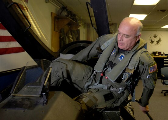 MISAWA AIR BASE, Japan -- Gen. Carrol H. "Howie" Chandler, Pacific Air Forces commander, climbs into the training cockpit during egress training prior to his flight Sept. 25, 2008. While here, General Chandler thanked the 35th Fighter Wing for all their work. (U.S. Air Force photo by Senior Airman Chad Strohmeyer)