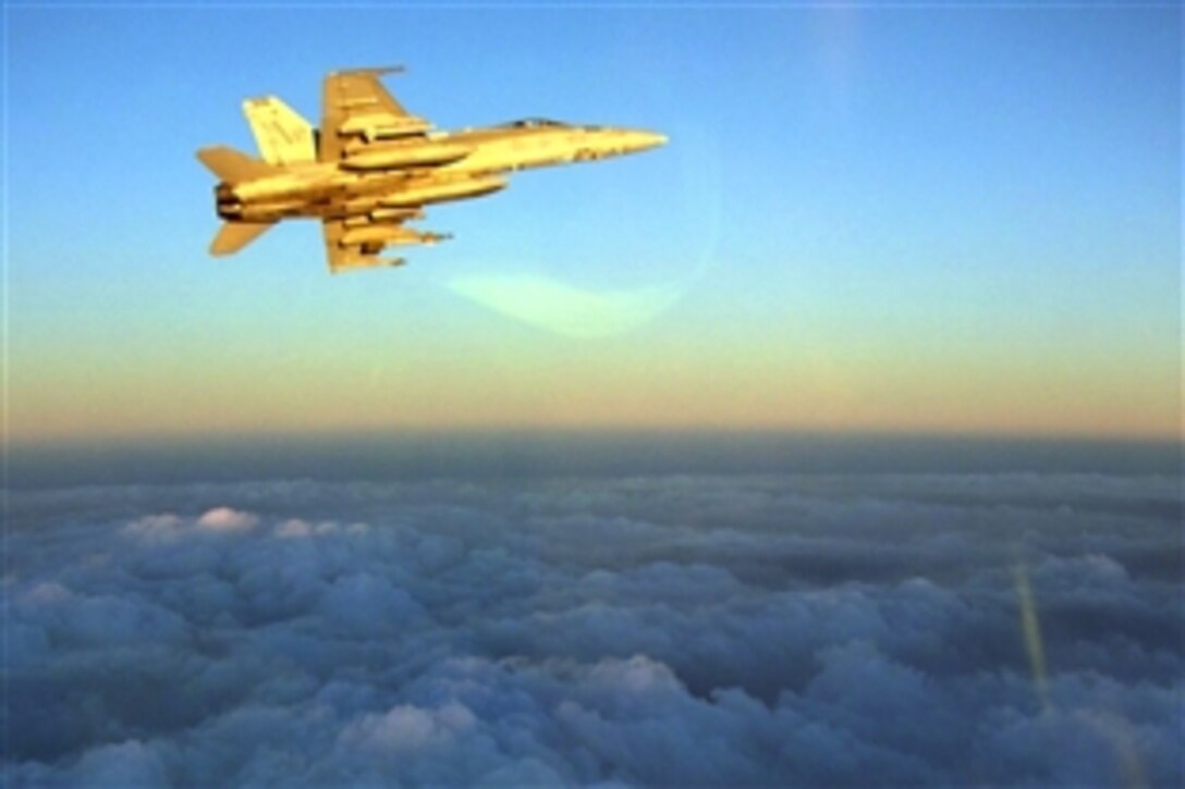 An F/A-18C Hornet assigned to the "Stingers" of Strike Fighter Squadron 113 departs a tanker track in Southern Afghanistan to head back to the Nimitz-class aircraft carrier USS Ronald Reagan while two other Hornets join a British Royal Air Force L-1011 aerial refueling aircraft. Ronald Reagan is deployed to the U.S. 5th Fleet area of responsibility, Sept. 27, 2008.