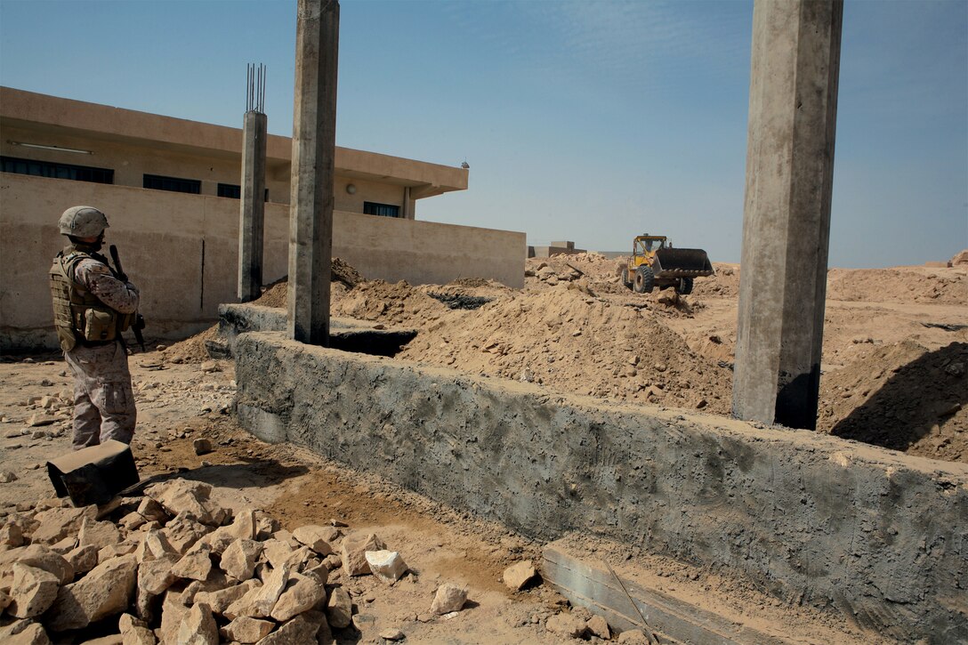 KHALIDYAH, Iraq – A Marine from 2nd Battalion, 11th Marine Regiment, Civil Affairs, Detachment 3, Team 4 with Task Force 1st Battalion, 2nd Marines, Regimental Combat Team 1, inspects construction progress of the Khalidyah Courthouse, Sept 29. When completed the court house will provide offices and a courtroom for the Habbaniyah judiciary. (Official U.S. Marine Corps photo by Lance Cpl. Scott Schmidt)